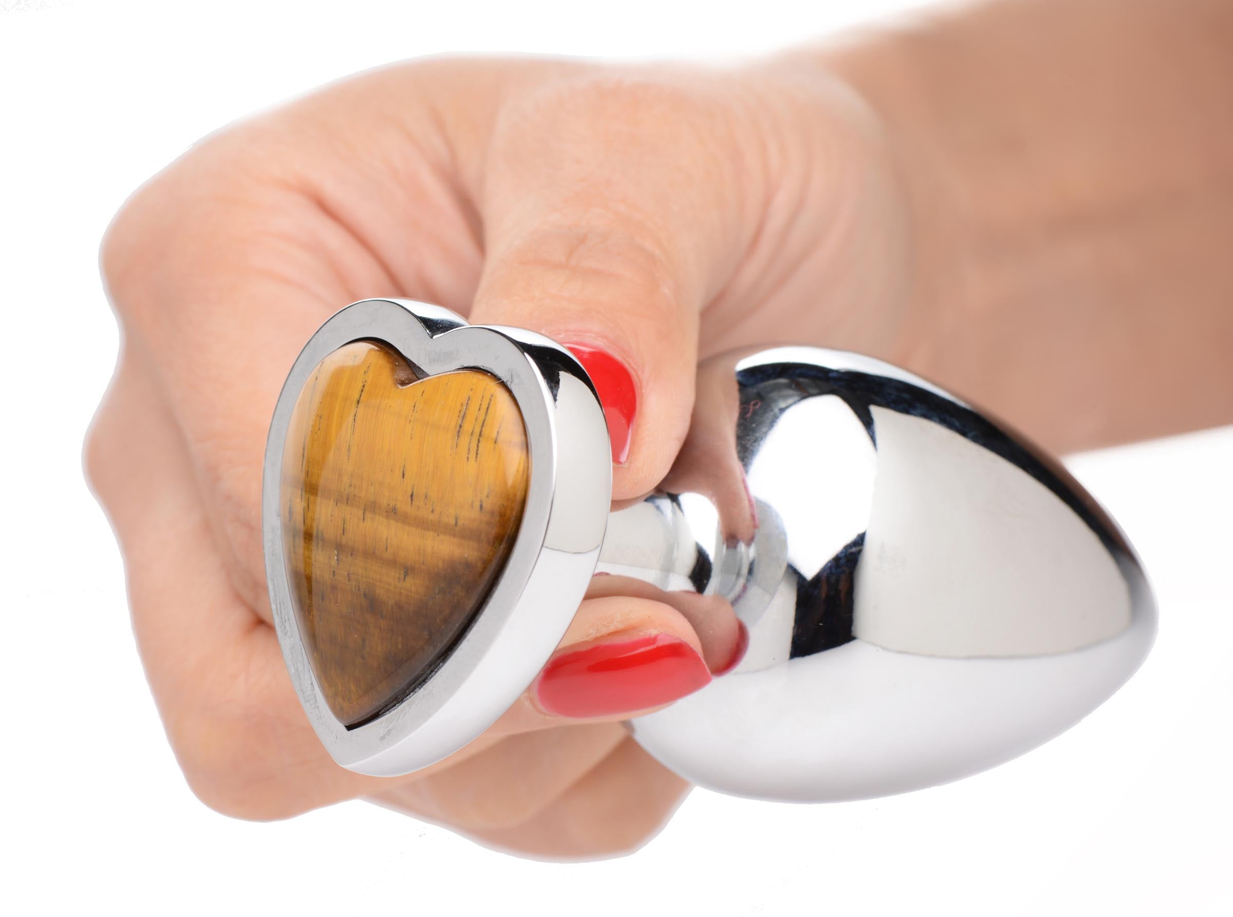 Hand holding the Tigers Eye heart-shaped anal plug to show size