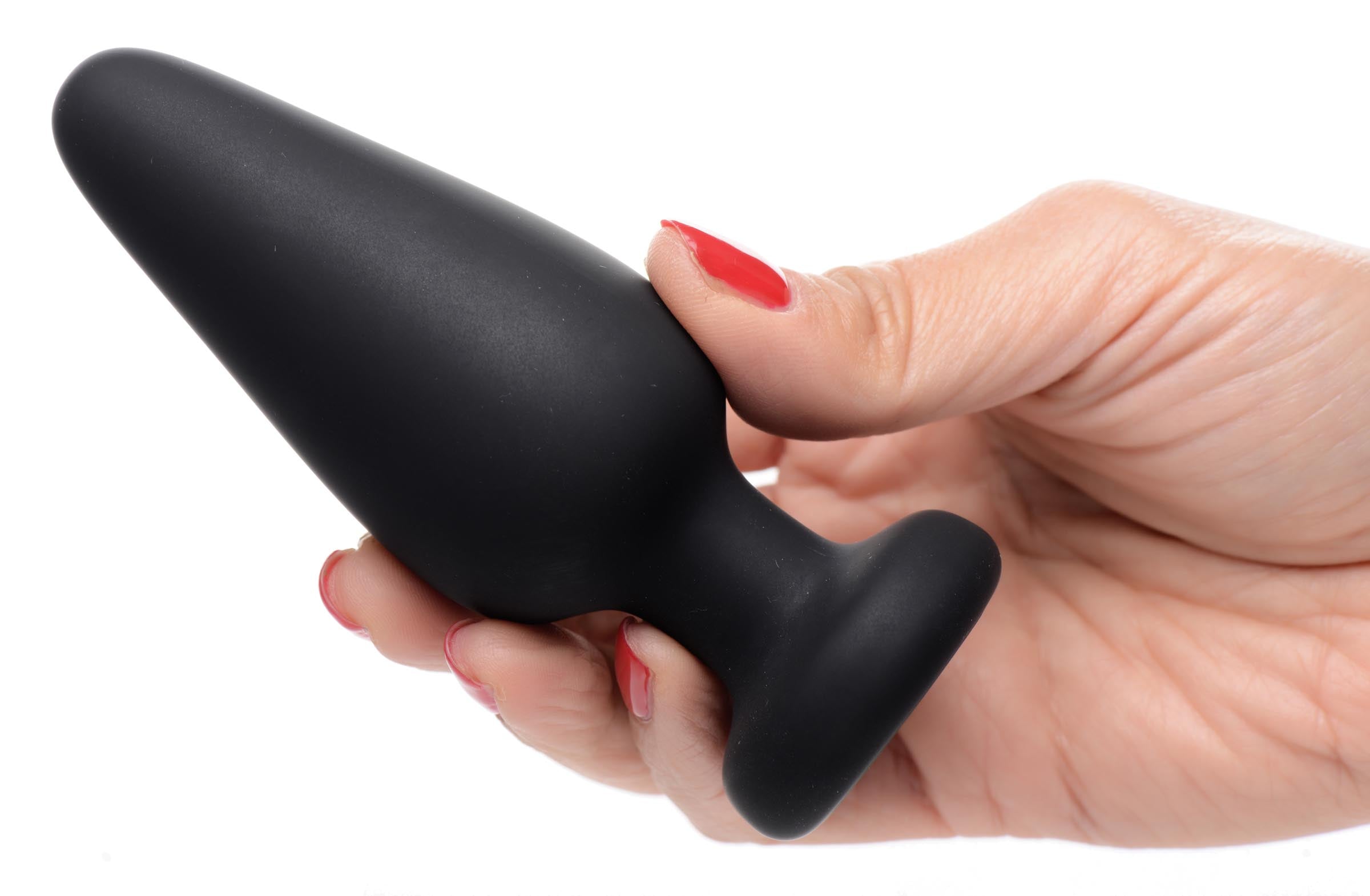 A person holding a light-up silicone anal plug