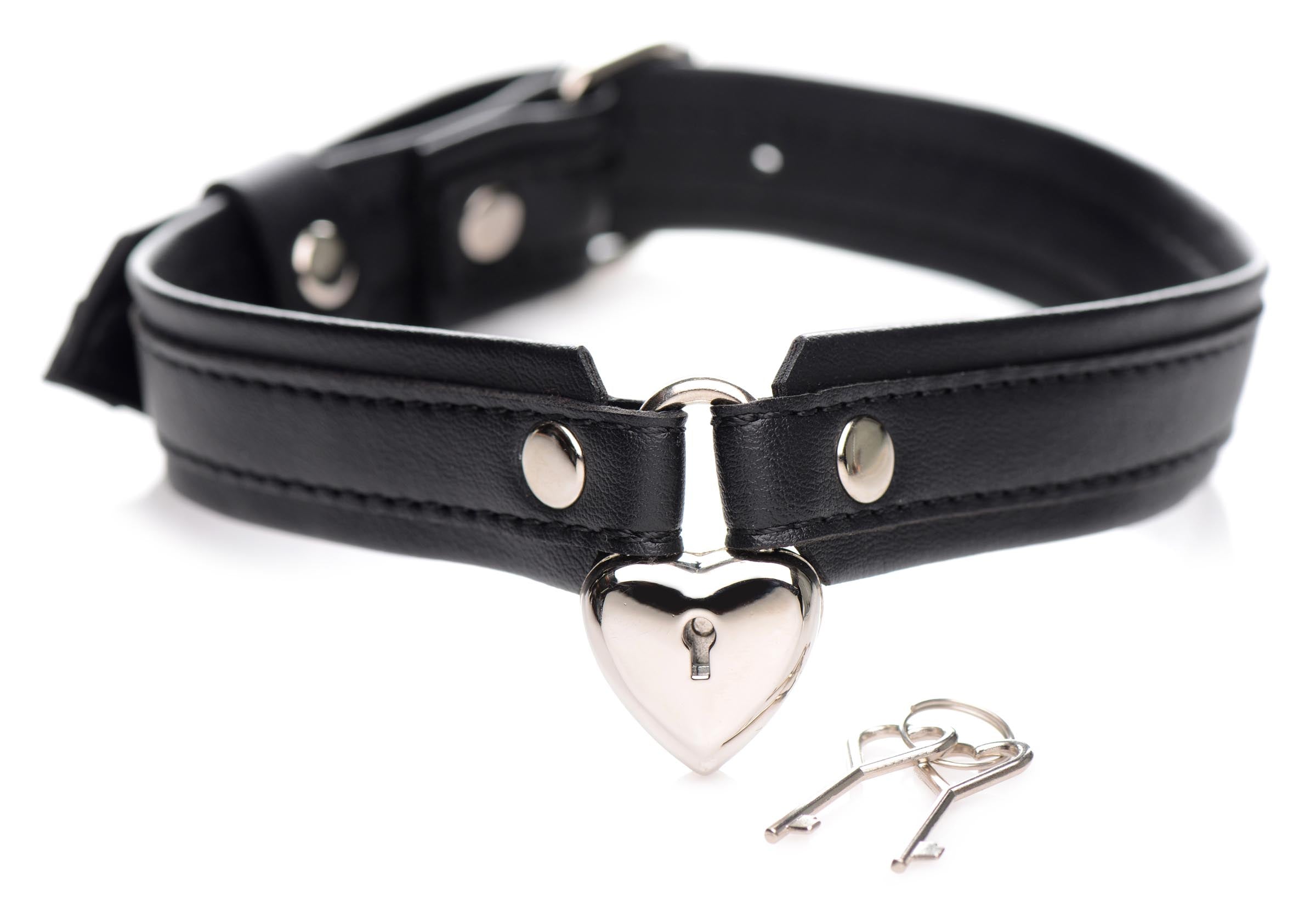 Close-up view of a black leather heart collar with a locking mechanism