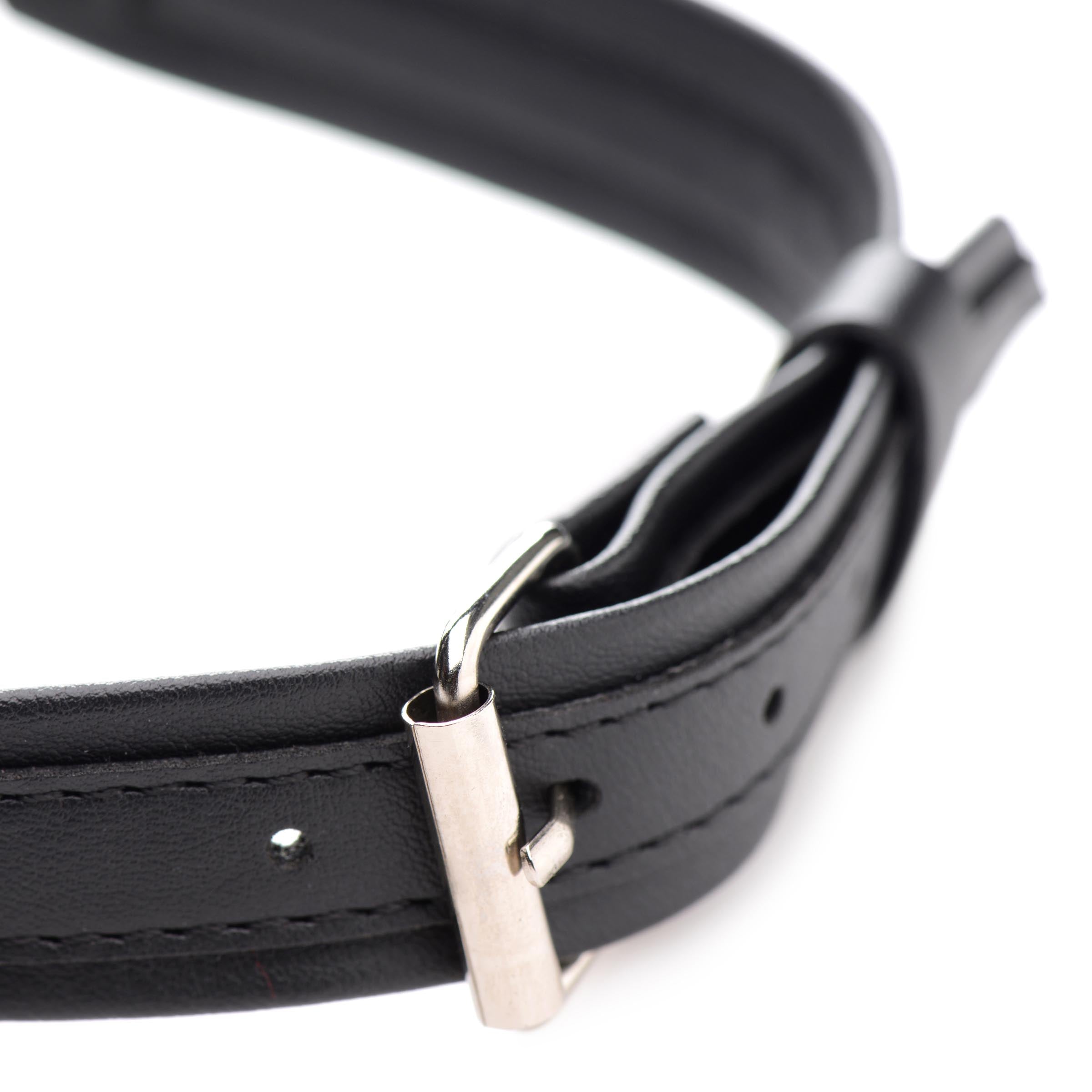 Detailed image of the heart-shaped lock on a black leather collar