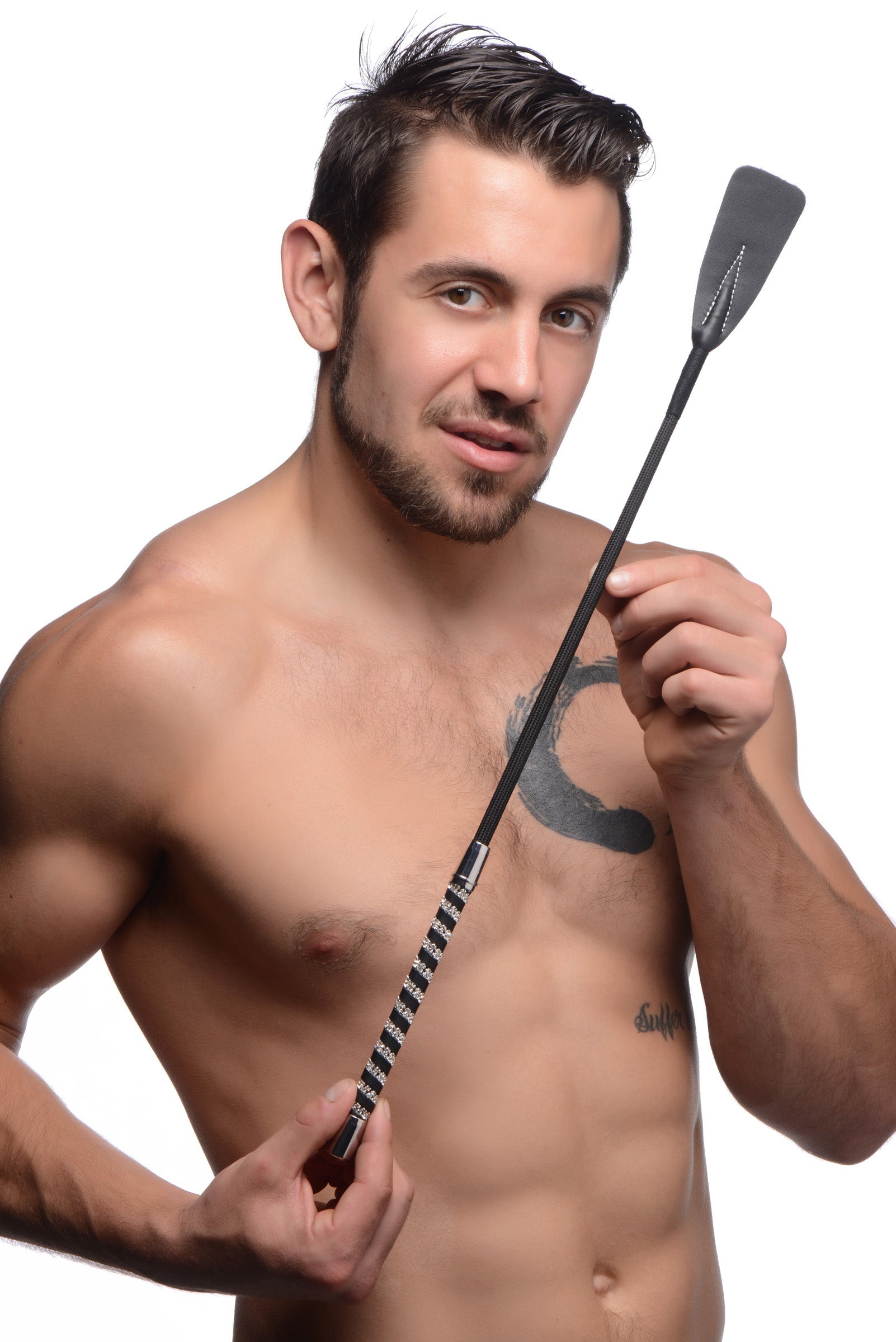 Close-up of a short leather riding crop with a rhinestone handle in a man's grip