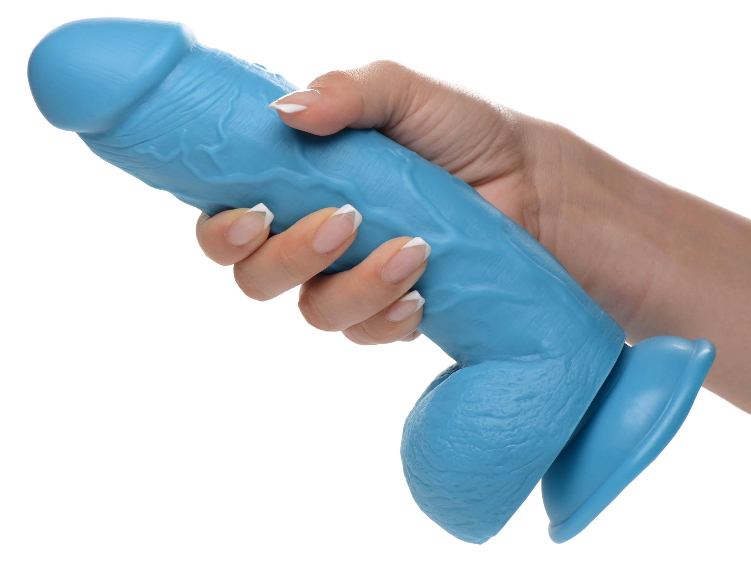 8.25 inch blue dildo with balls being held by a woman's hand