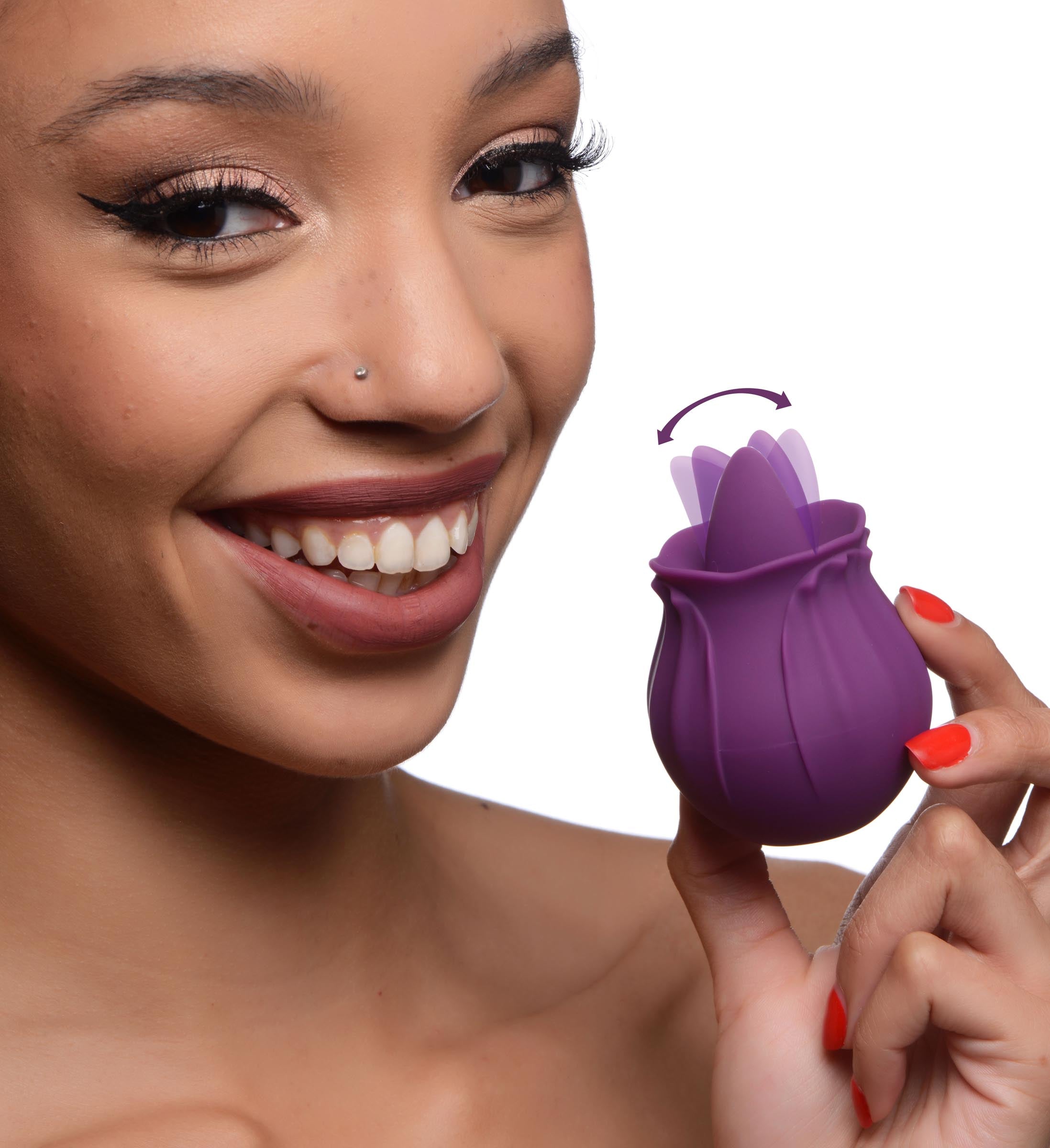 Woman holding the Bloomgasm Wild Violet clit licking stimulator with an egg-like design