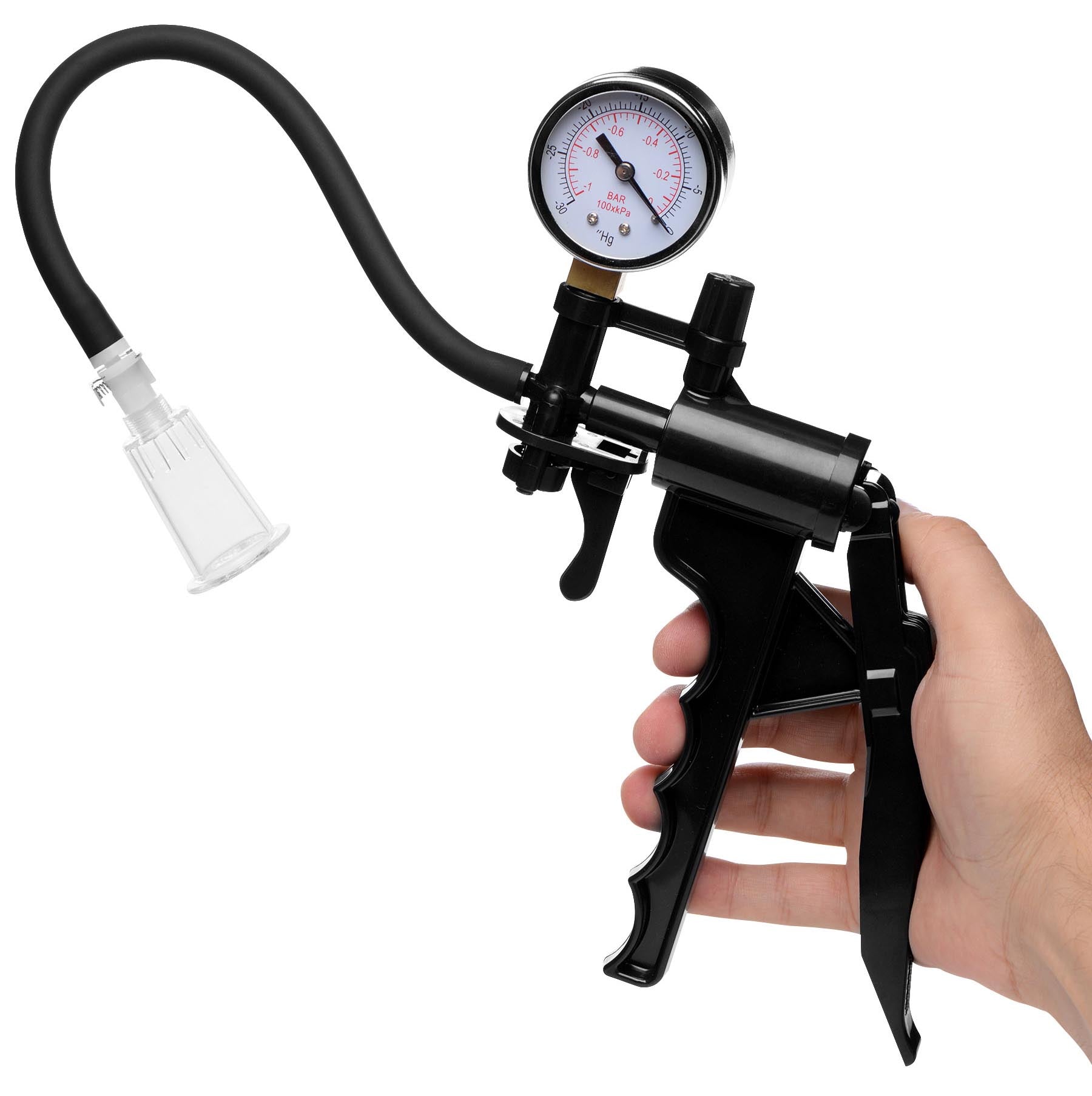 Hand operating a manual pump with pressure gauge for clitoris enhancement