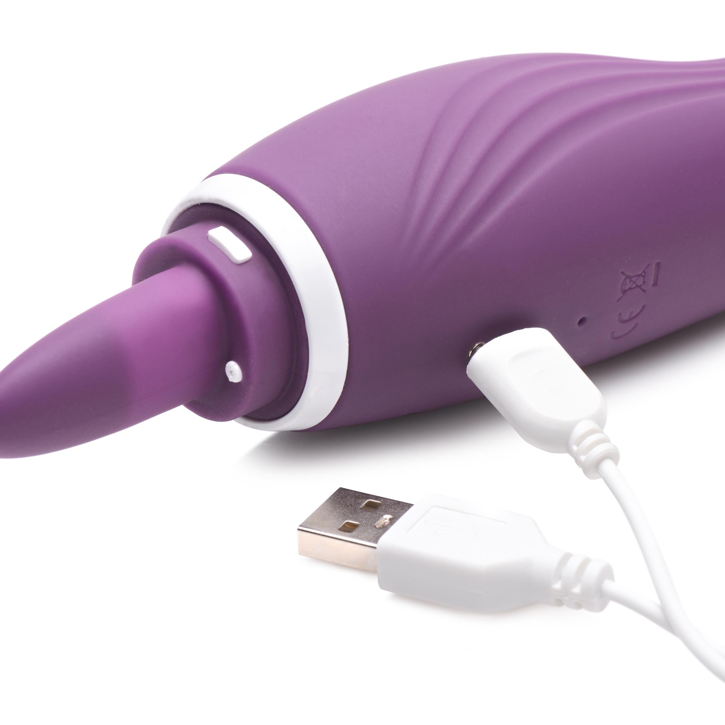 The Lickgasm 8x vibrator with a USB charging cable attached