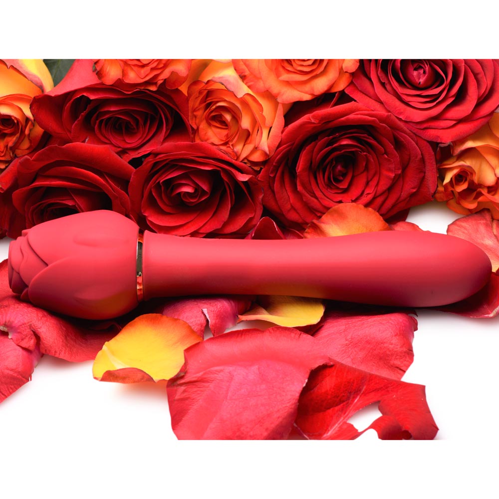 Bloomgasm Sweet Heart Rose Clitoral Suction Vibrator resting among a bouquet of roses