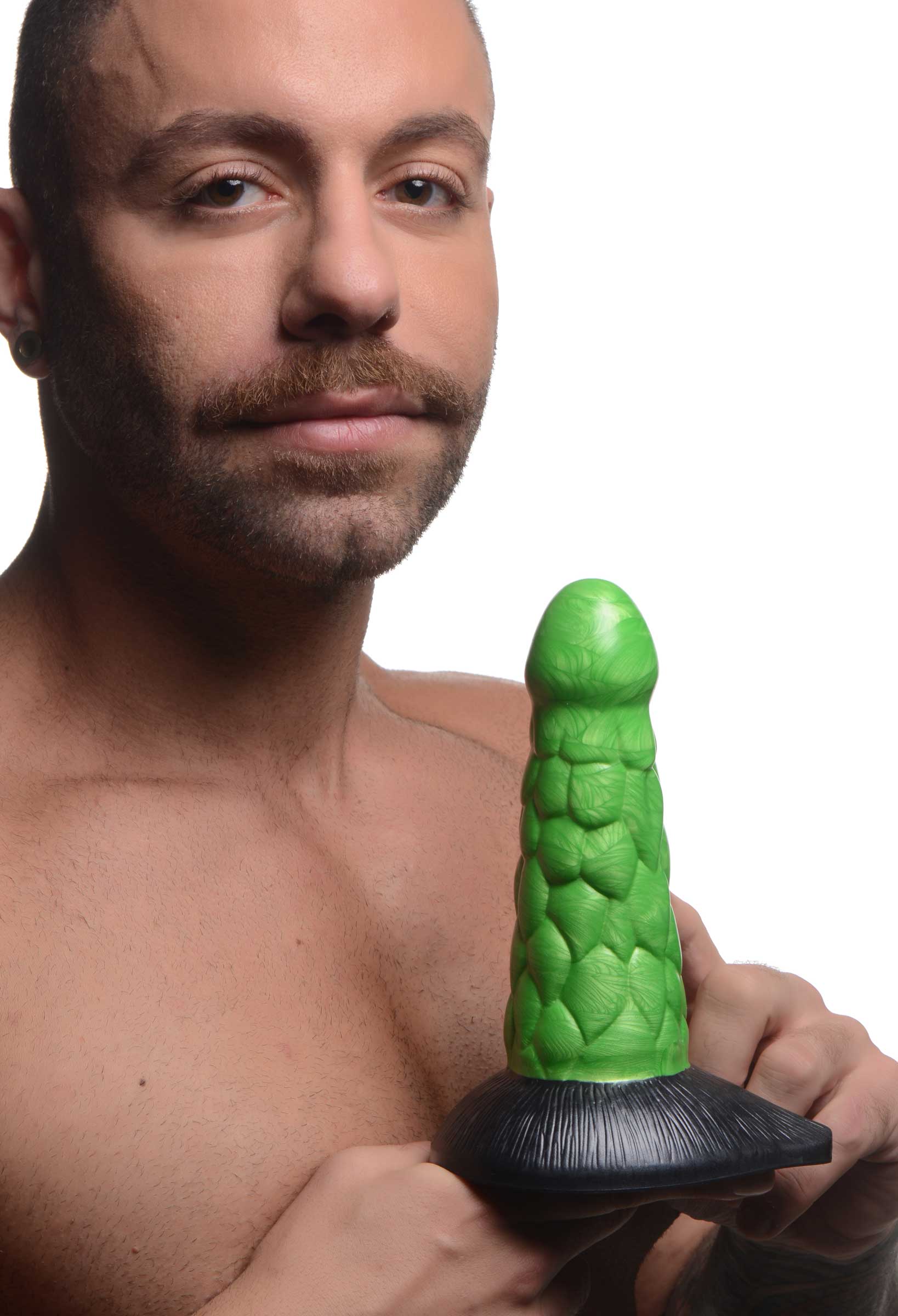 Torso of a man without a shirt holding a reptilian-themed silicone dildo