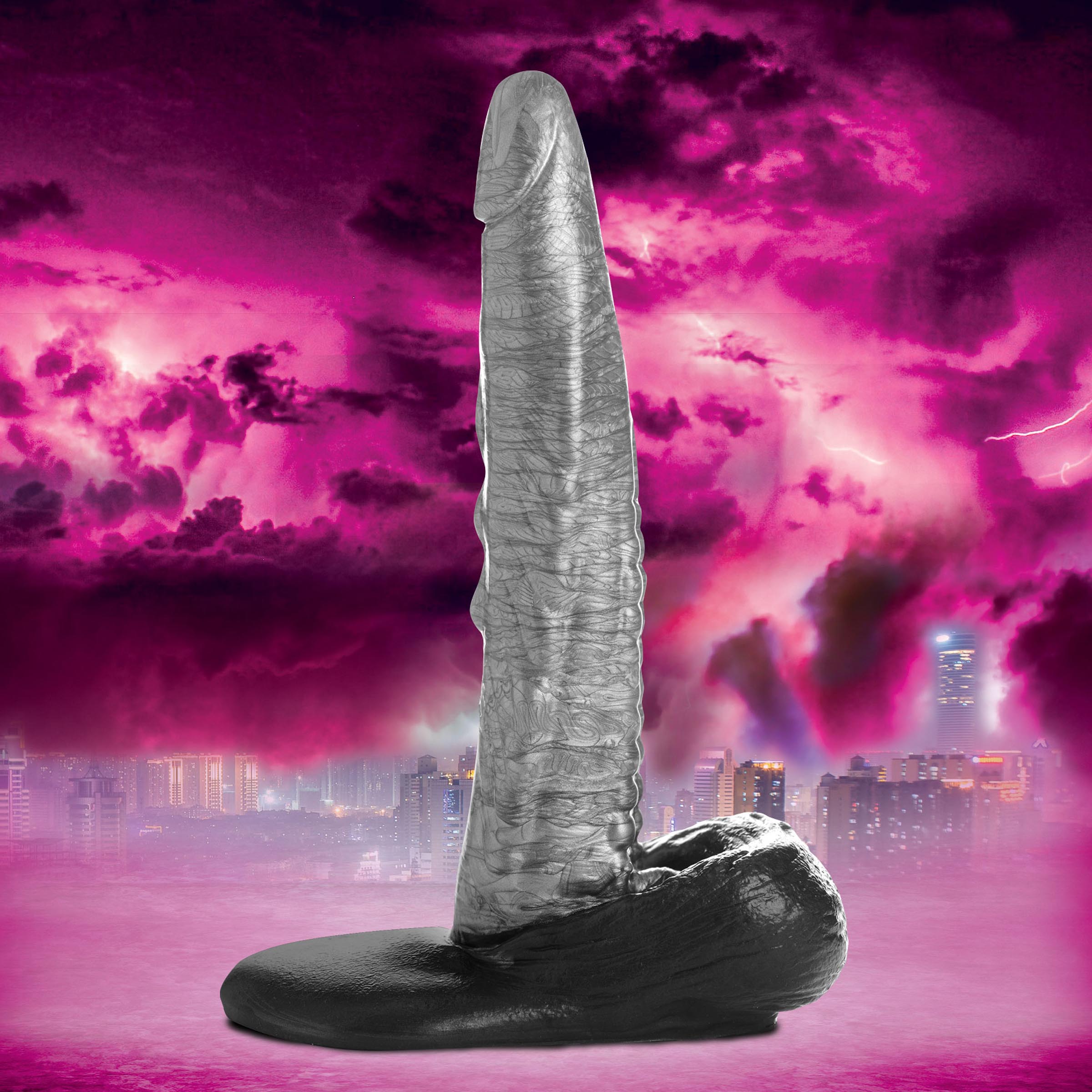 Gargoyle-themed black and white silicone dildo against a purple backdrop