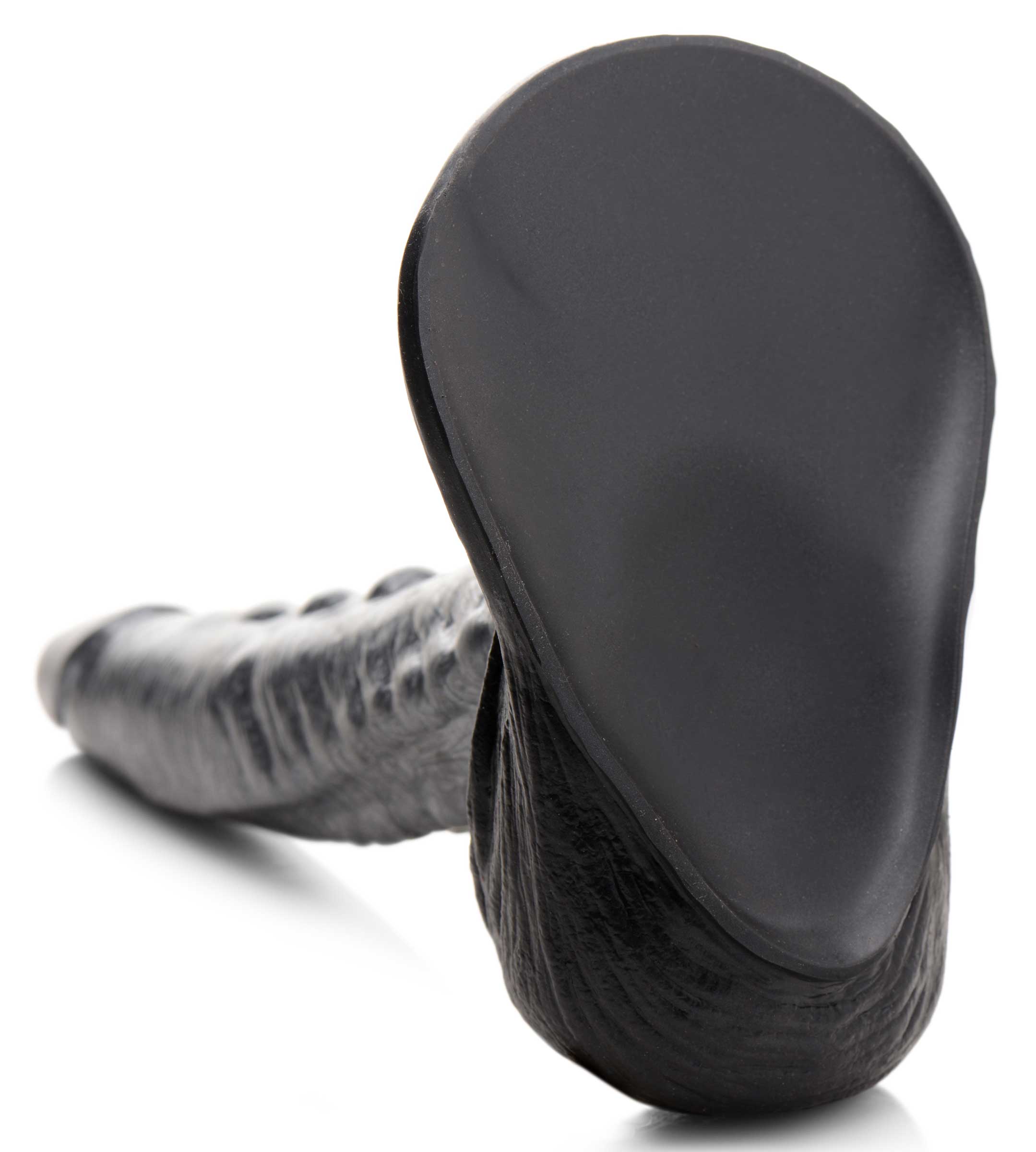 Silicone dildo with a textured black design resembling a gargoyle