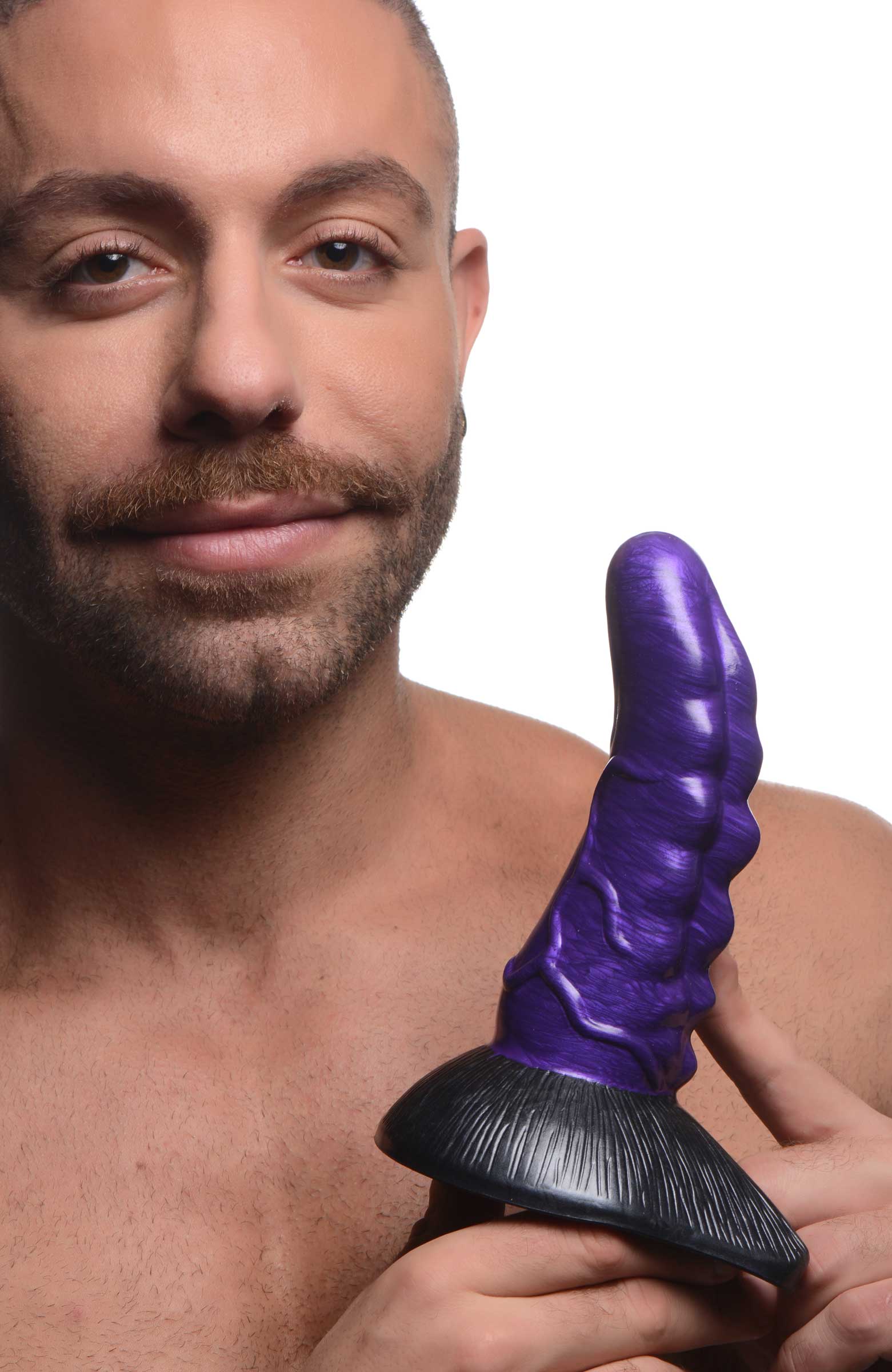 Person holding the Orion Invader Alien Dildo to display its size