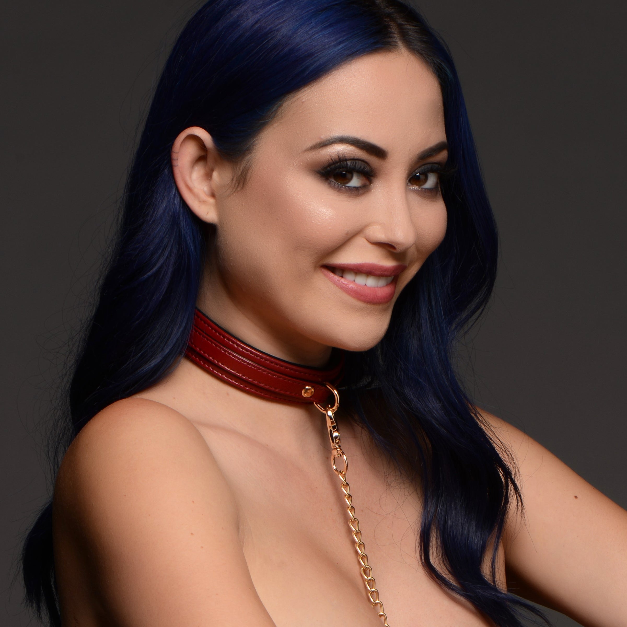 Blue-haired woman wearing a burgundy leather choker