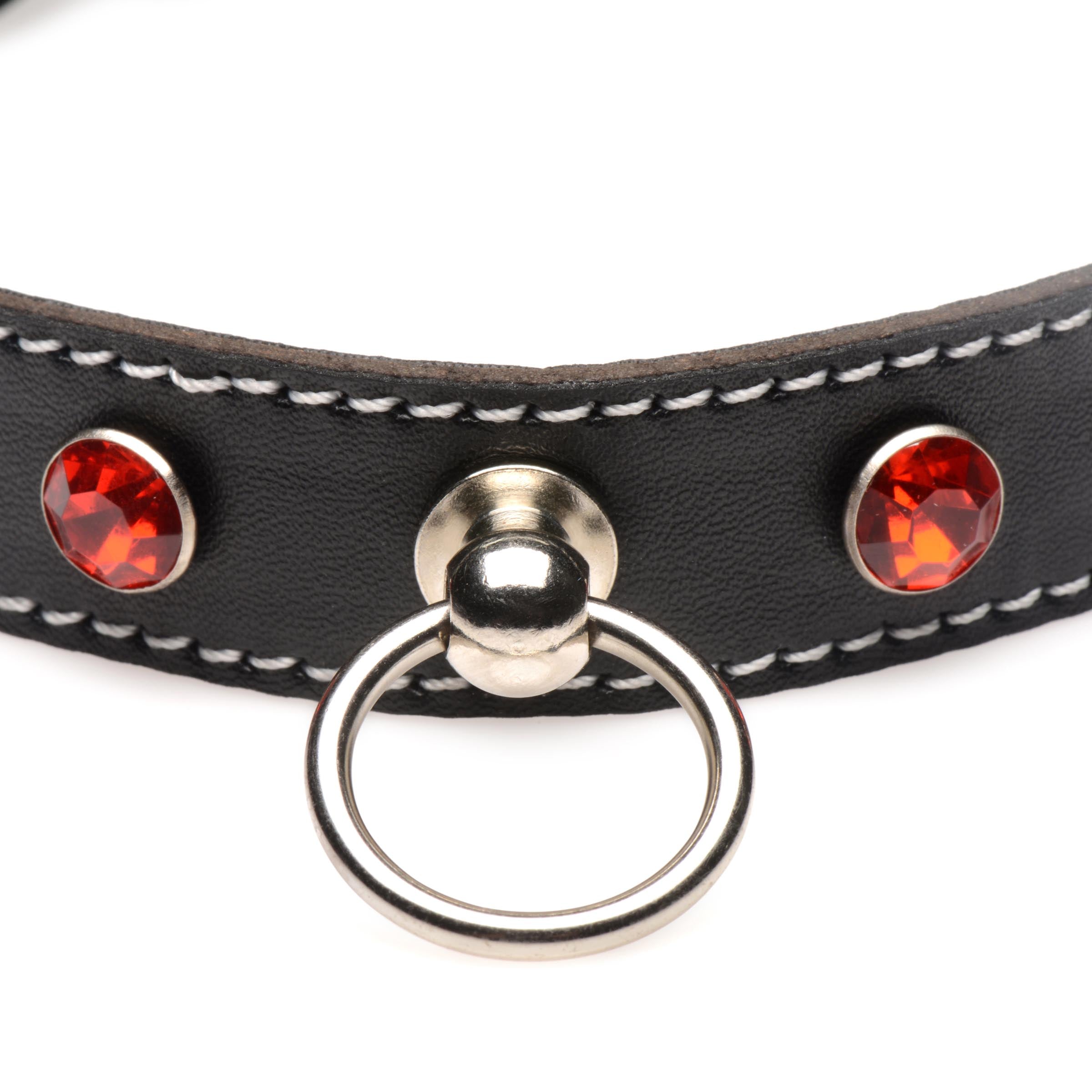 Close-up of a black leather choker with sparkling red and orange rhinestones and central O-ring