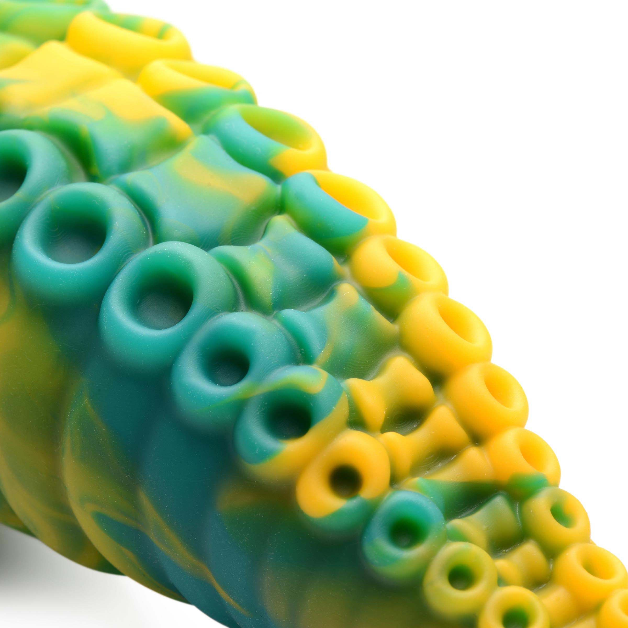 Detailed view of the green and yellow tentacle-textured dildo