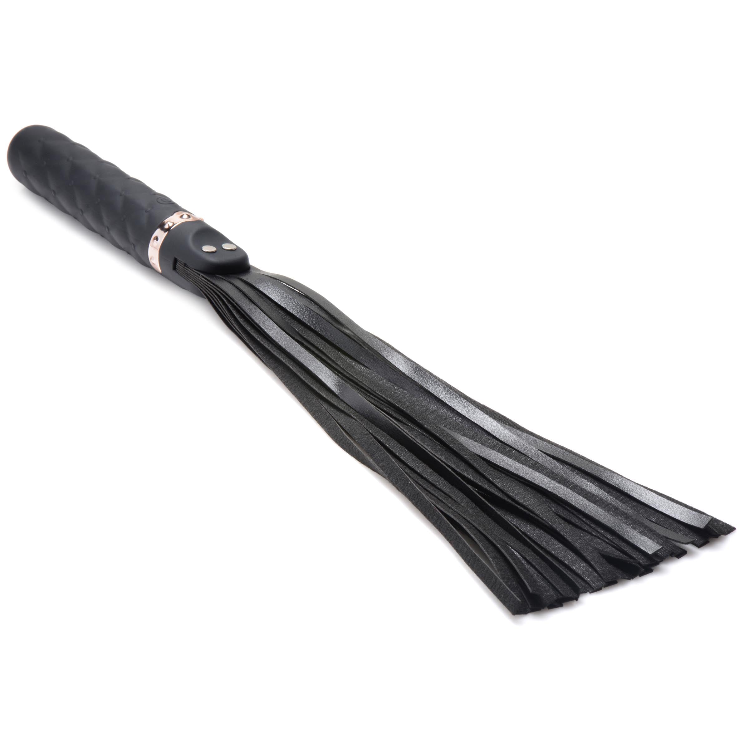 The 9x Vibrating Silicone Dildo Flogger featuring a tasseled end resembling a hairbrush