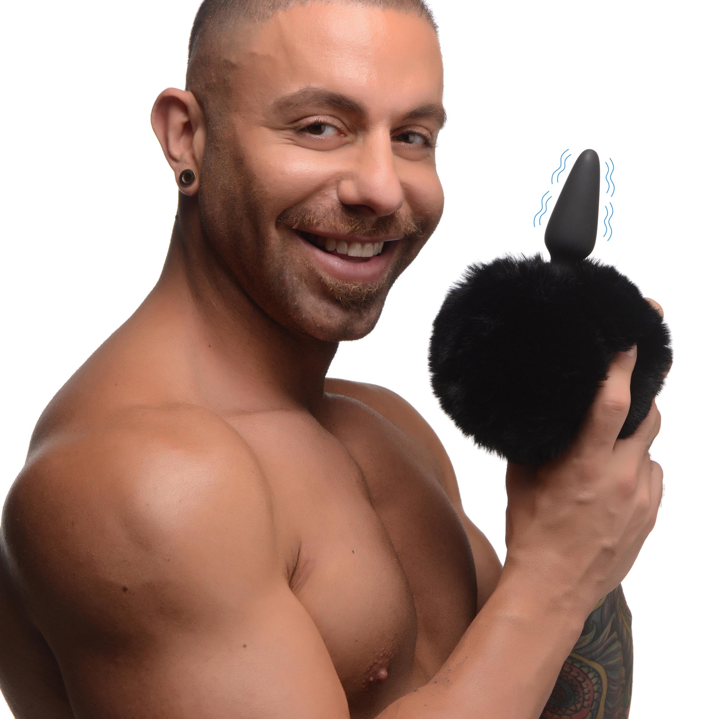 Man presenting the small vibrating anal plug with interchangeable bunny tail