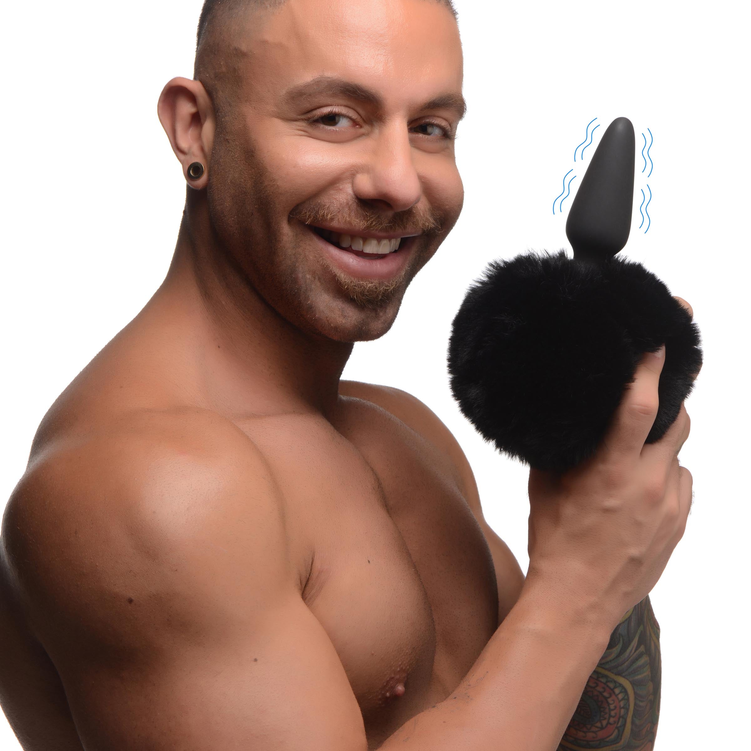 Man holding the large vibrating anal plug with bunny tail attachment