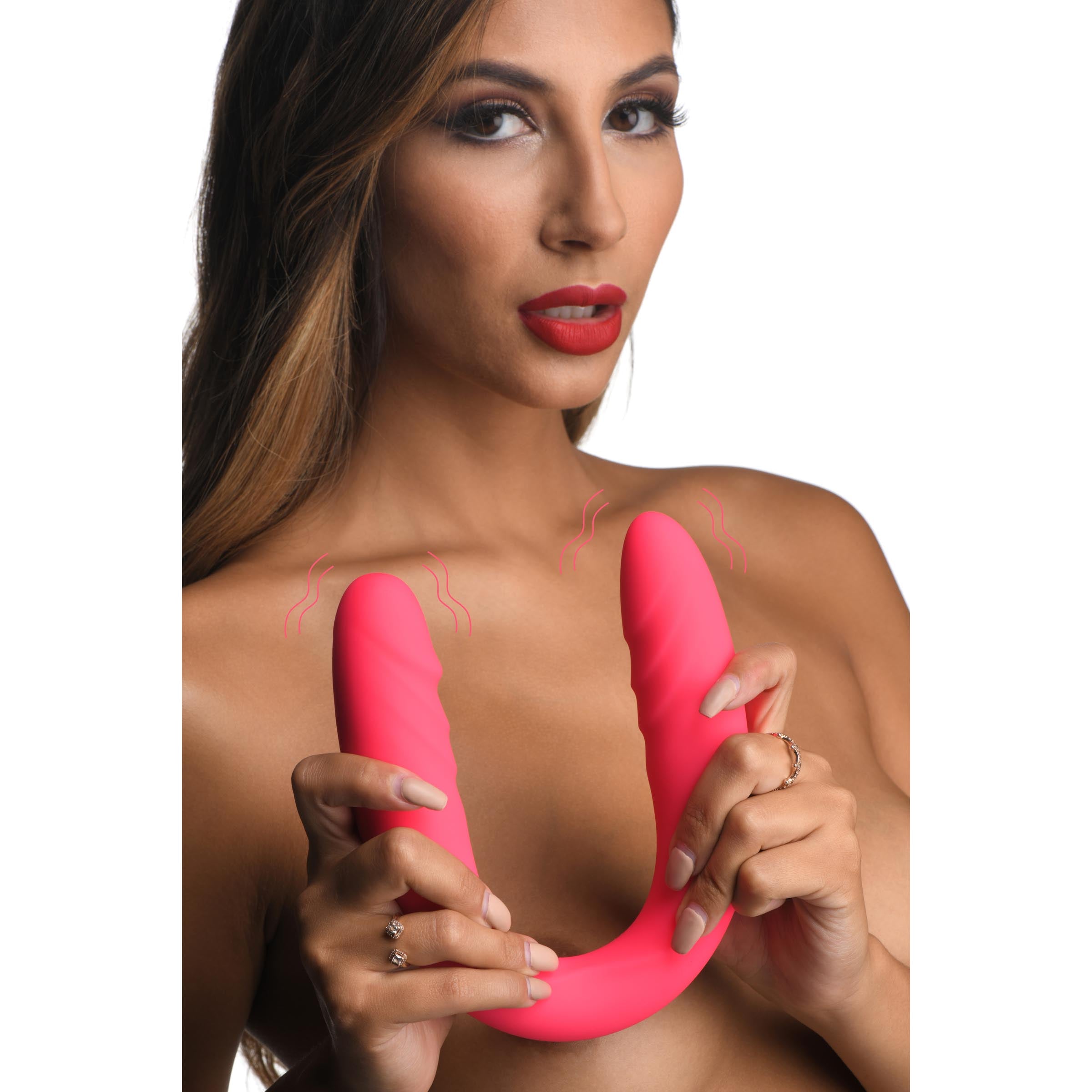 Person holding a silicone double-ended dildo with a remote control