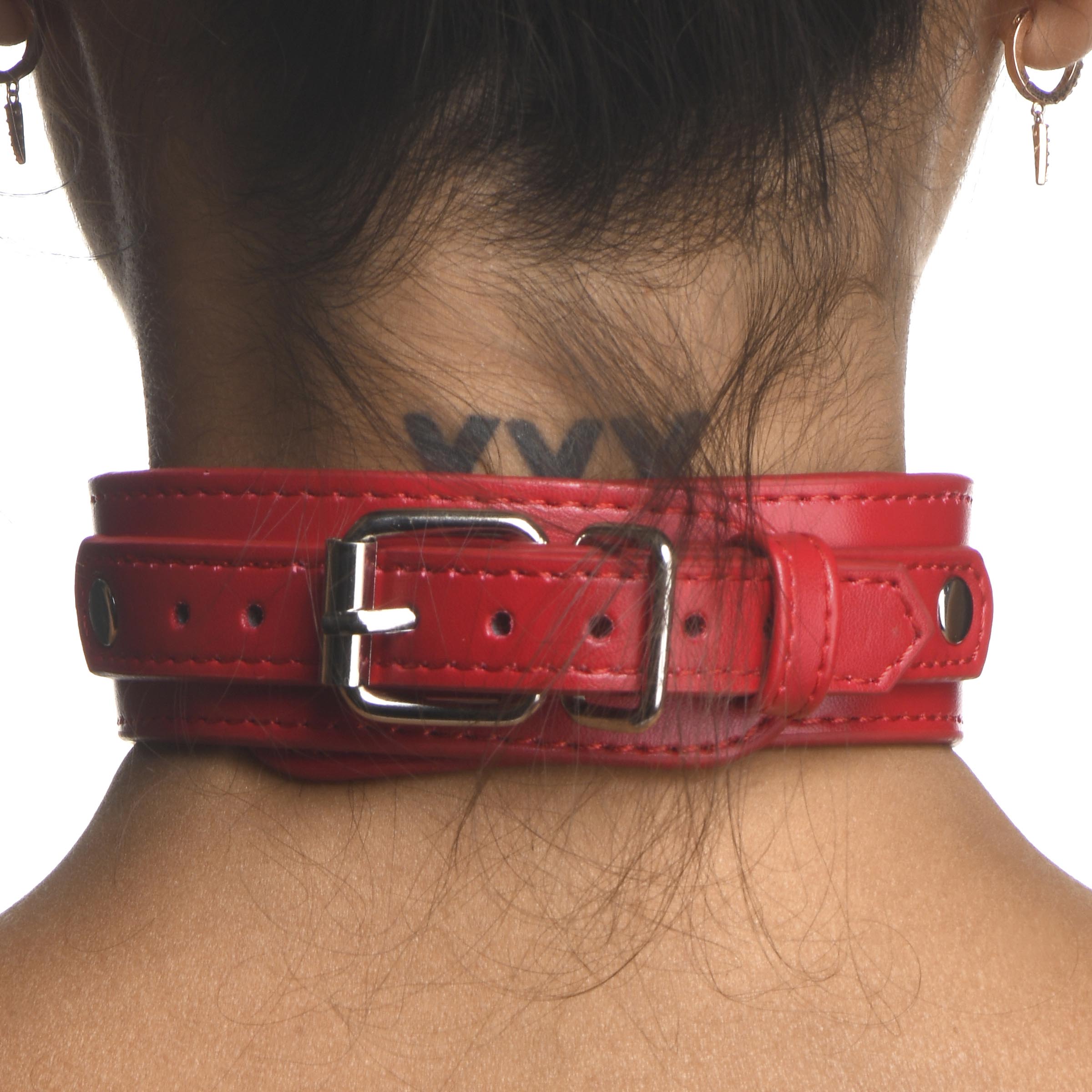 Side angle of a woman wearing a red leather chest harness with collar