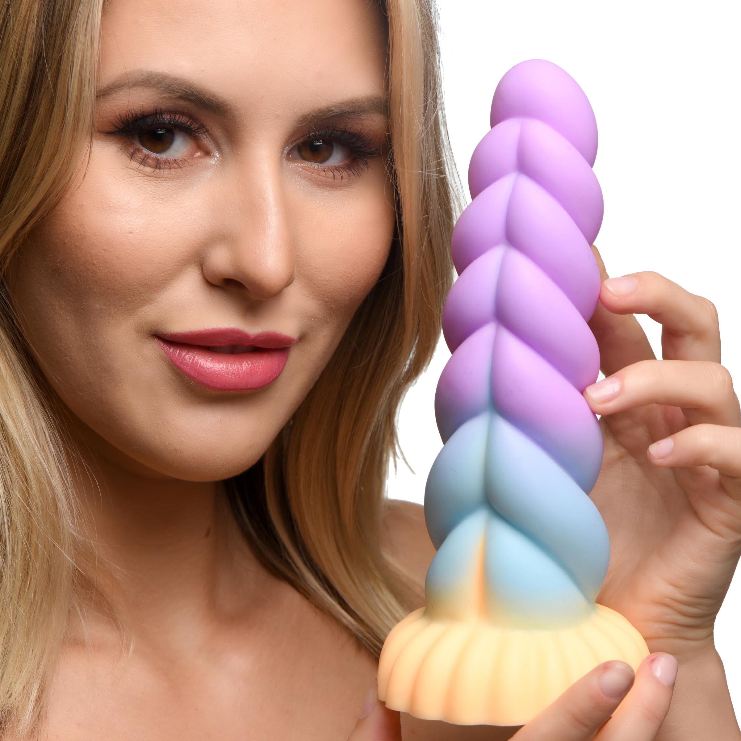 Woman displaying a silicone dildo with rainbow unicorn motif