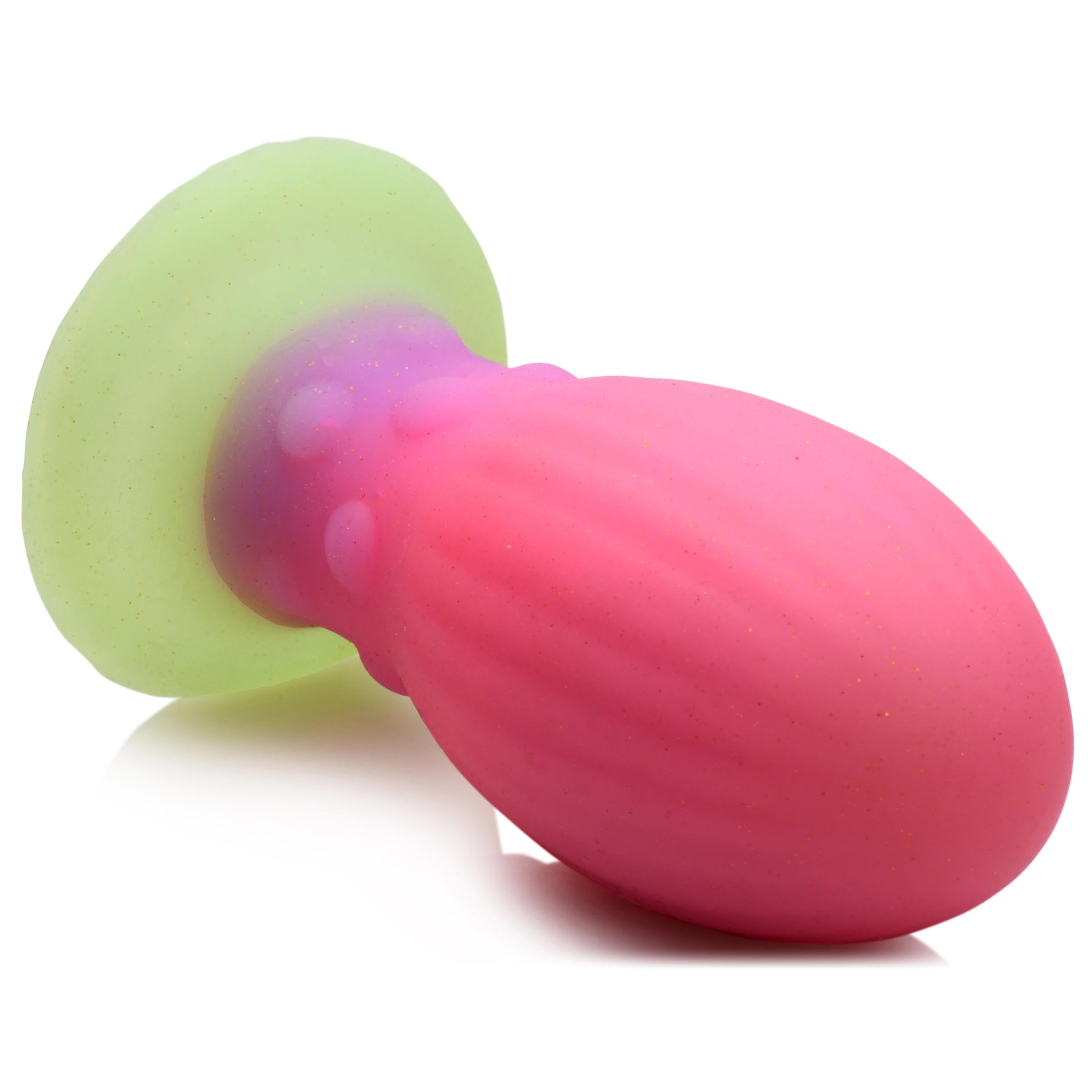 Close-up of the Xeno Egg silicone toy with its unique pink and green colors