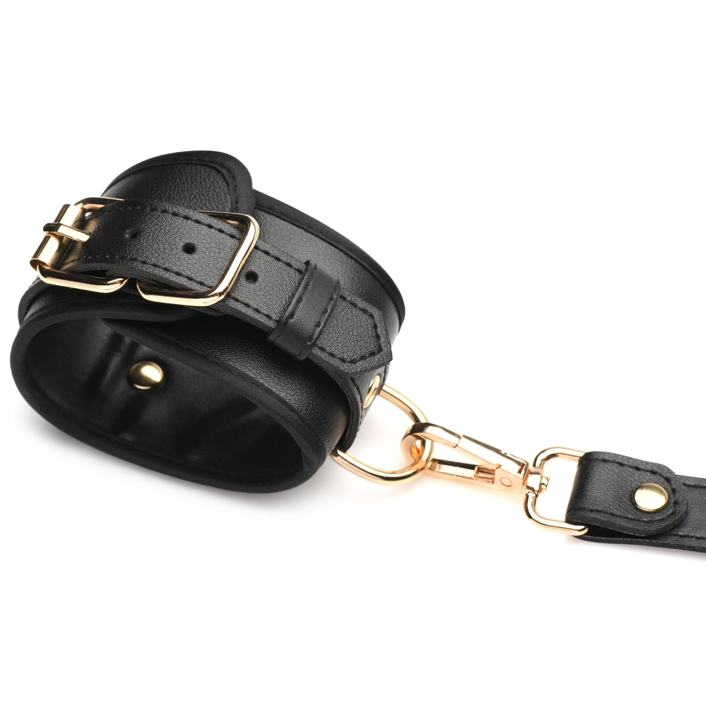 Black leather wrist cuffs with gold-tone hardware from the harness set