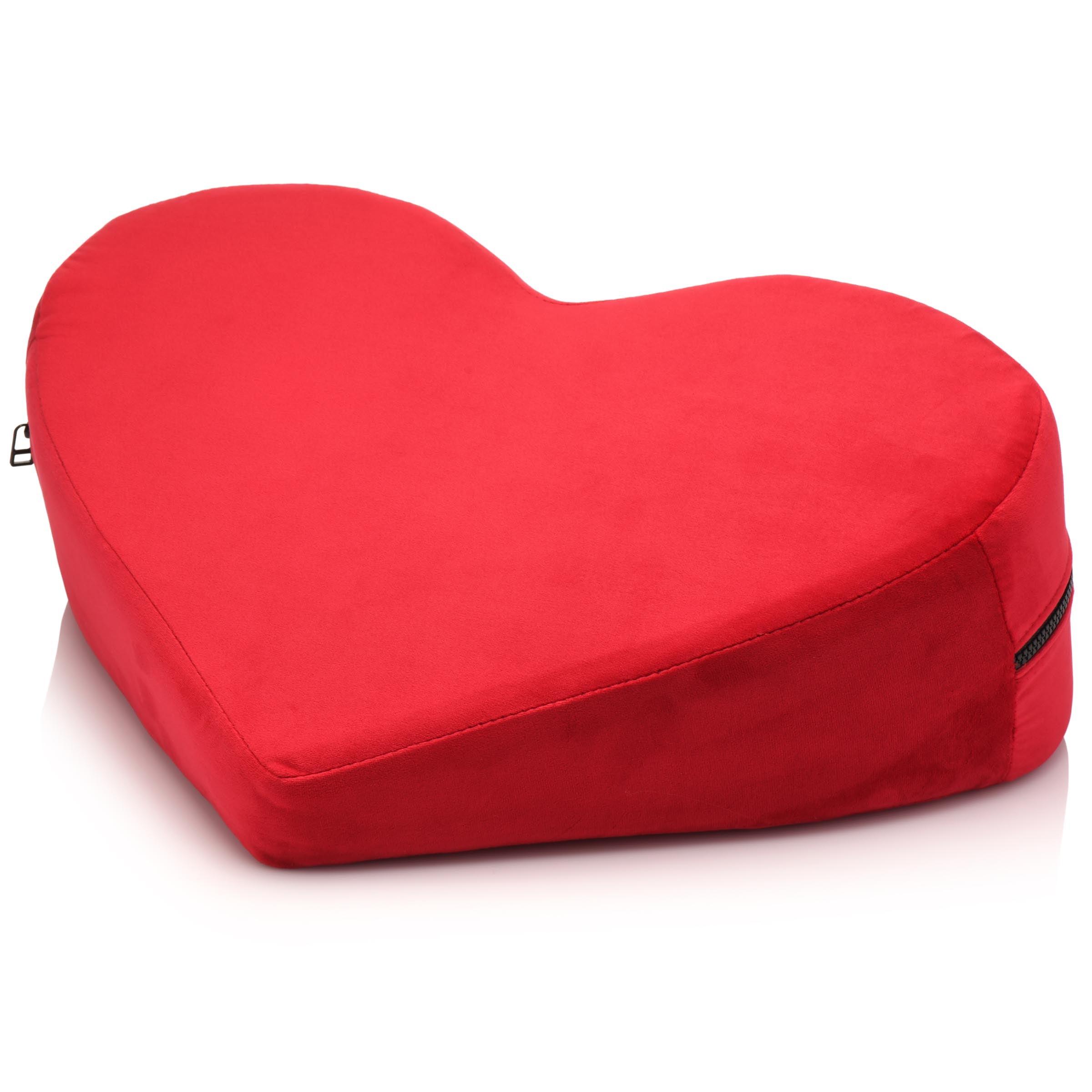 Plush red heart-shaped pillow in a cozy setting