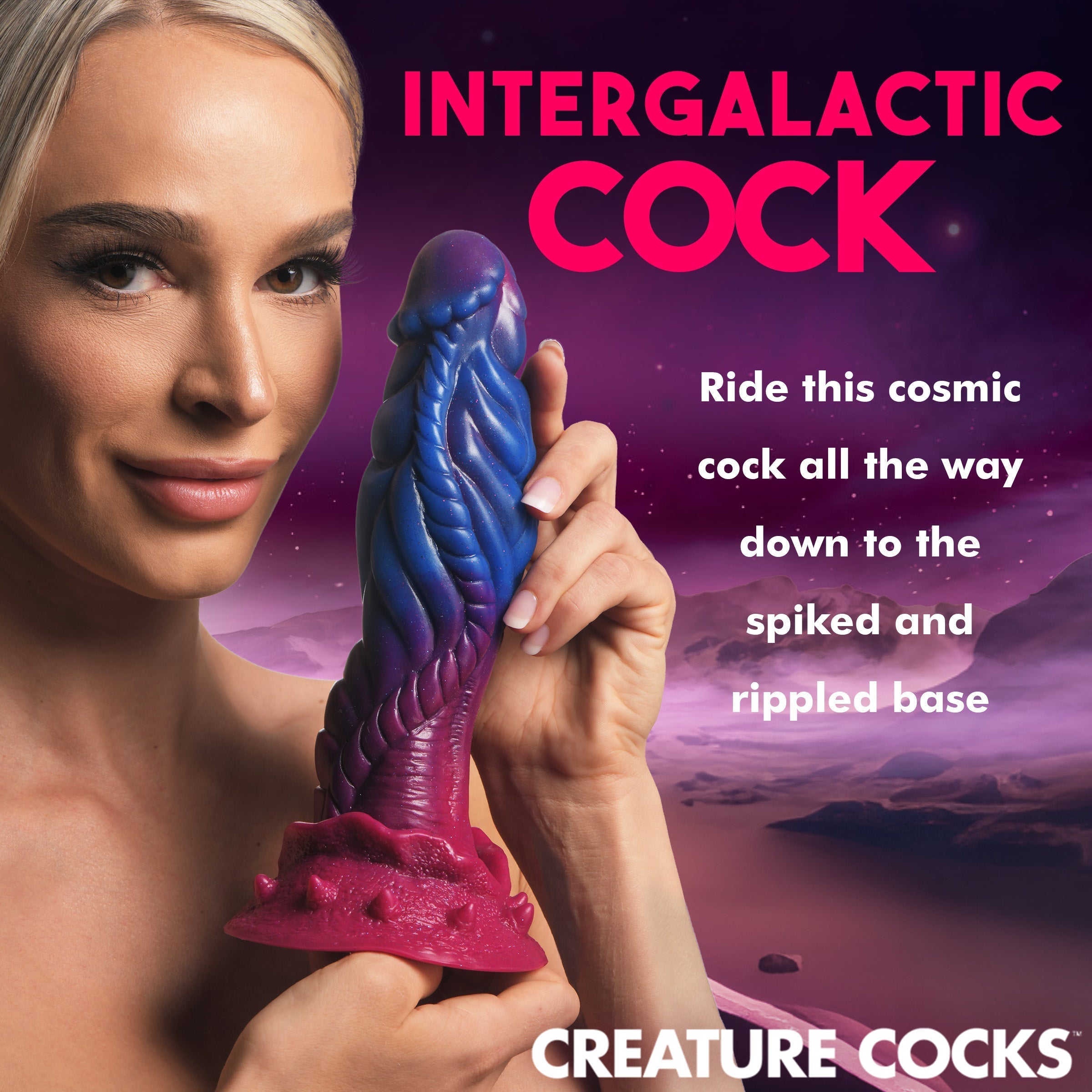 Hand holding a silicone dildo with intergalactic design elements