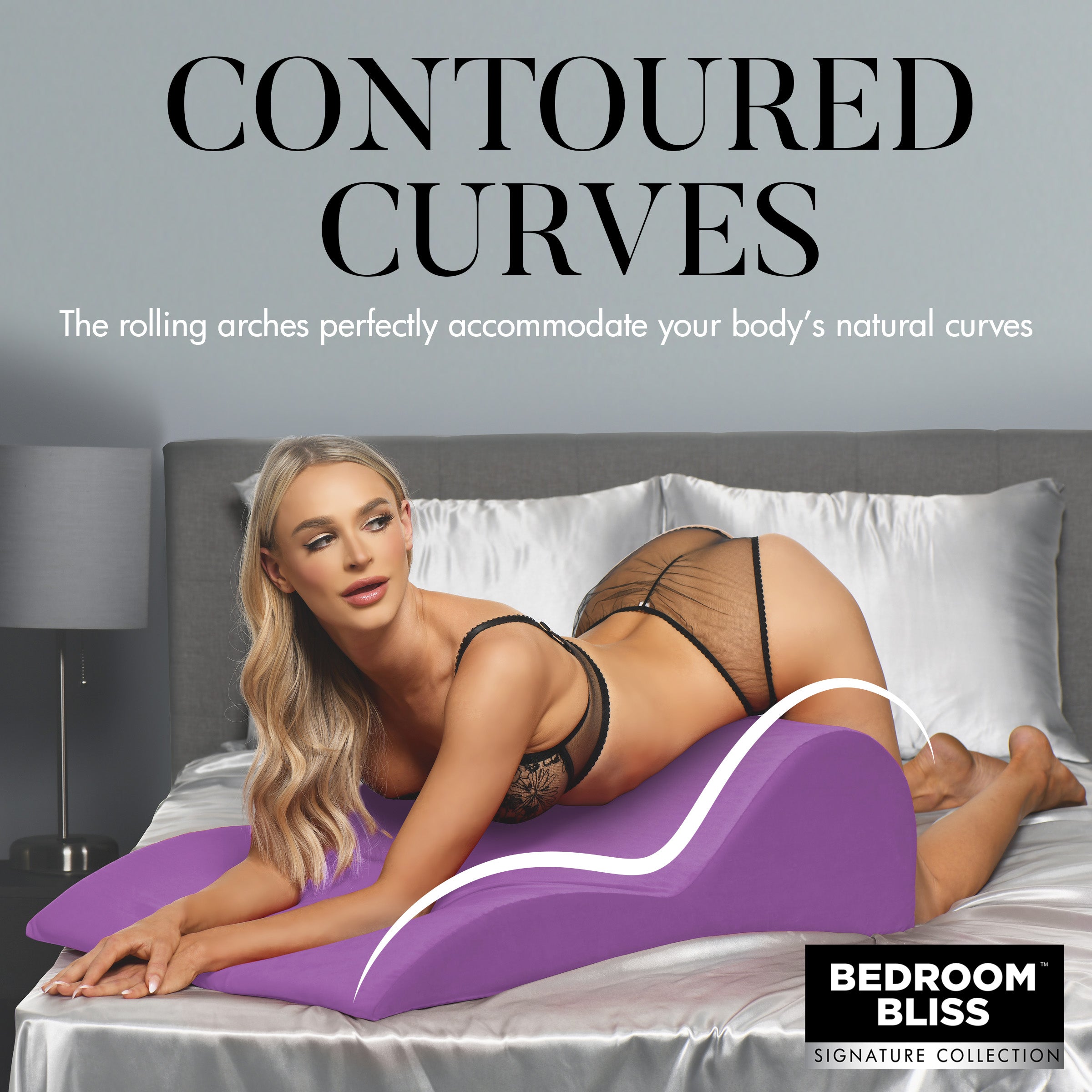 A model on a bed showcasing the curve-conforming design of the Contoured Love Cushion