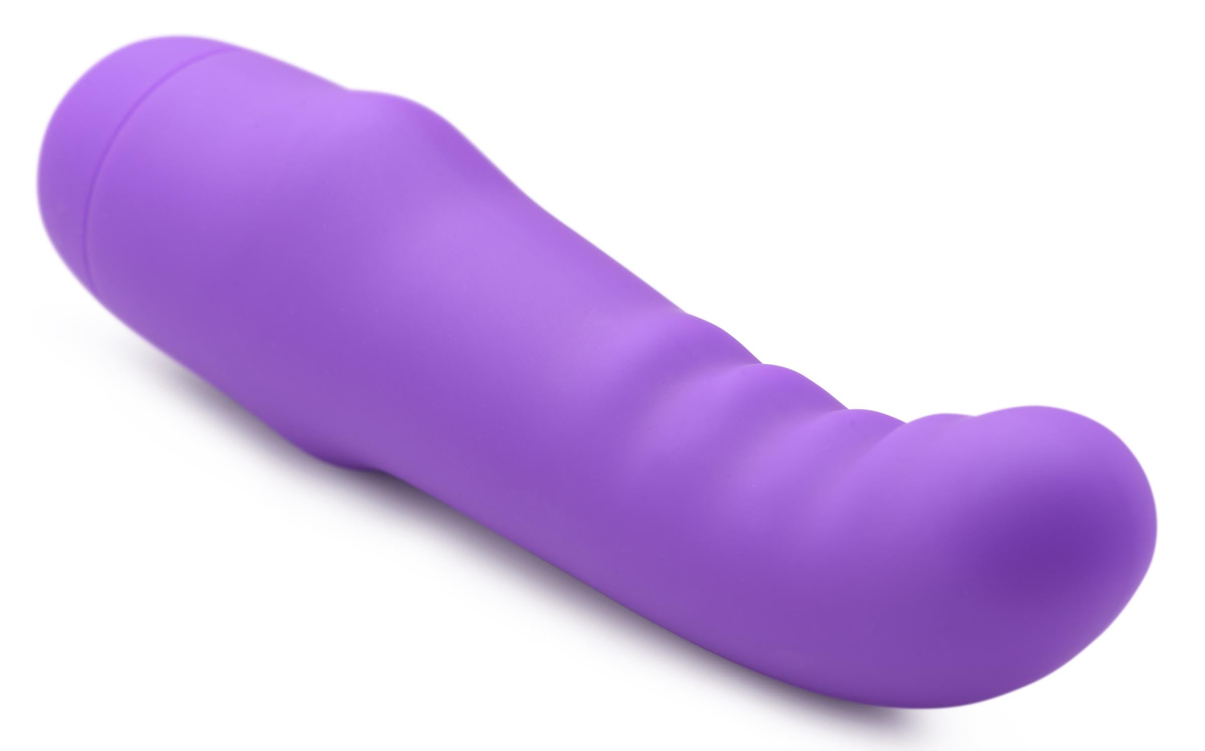 Purple G-spot vibrator lying on a flat white surface