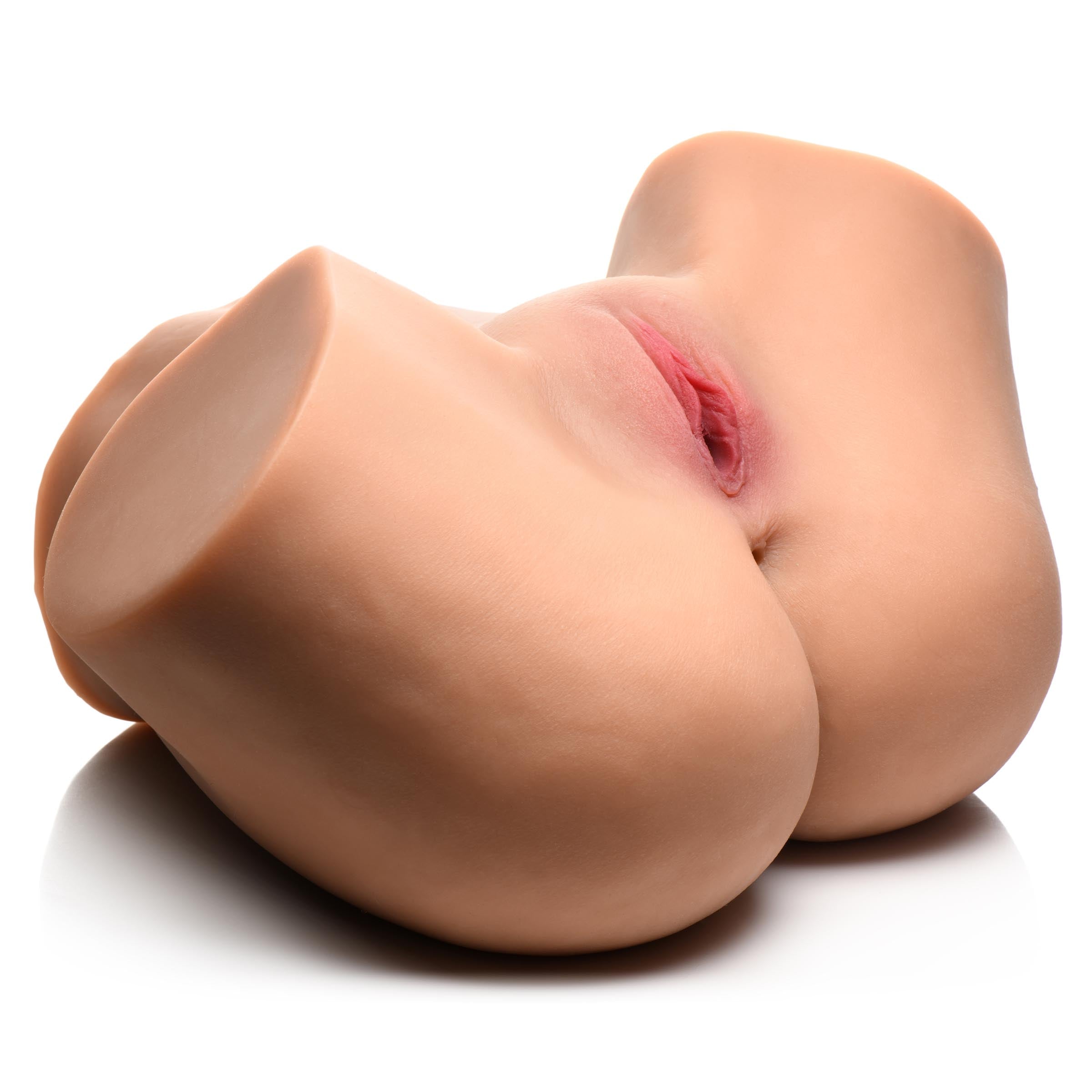 Close-up view of the masturbator toy designed to resemble female genitalia, displayed on a white background