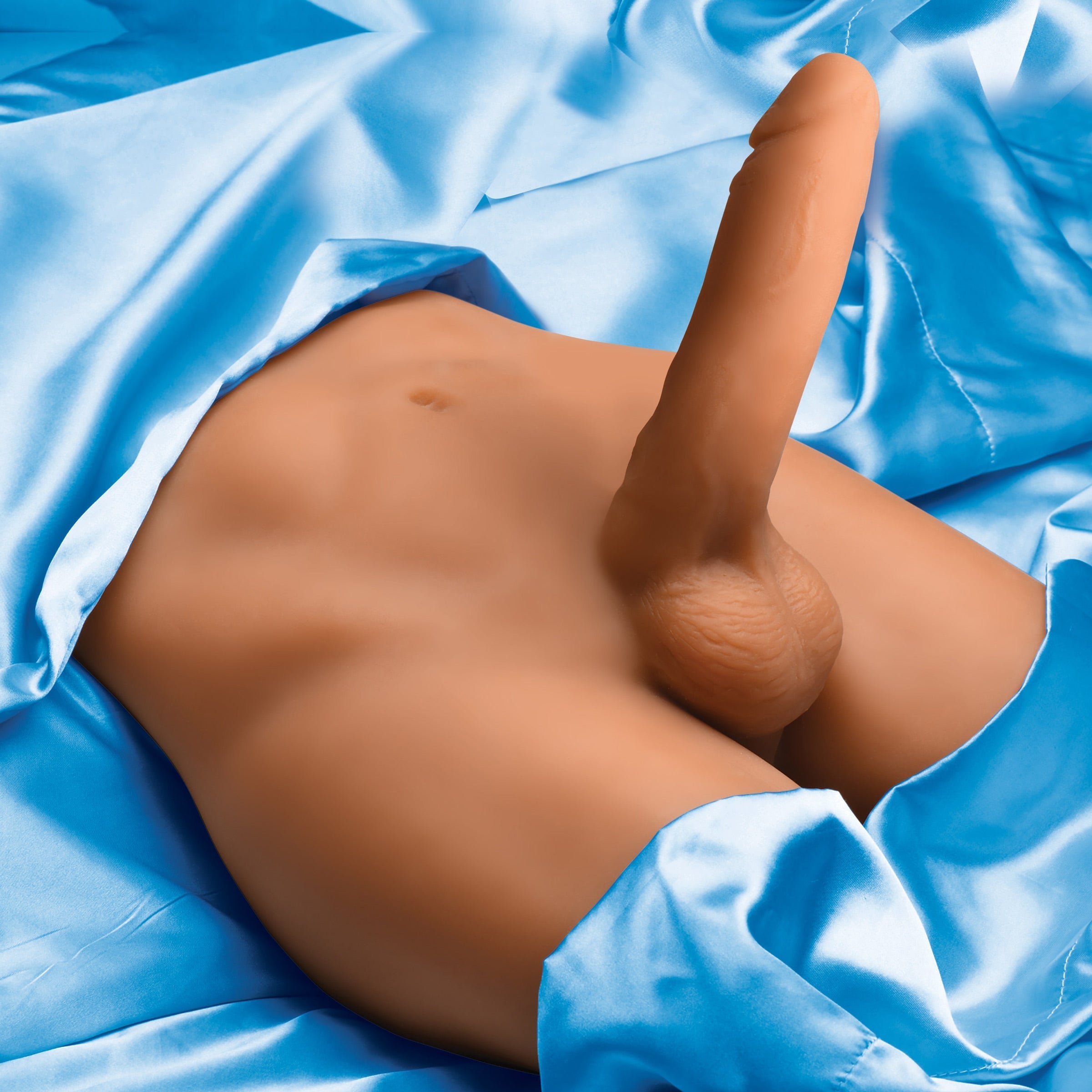 Realistic dildo attachment of the Jock Male Masturbator on blue fabric