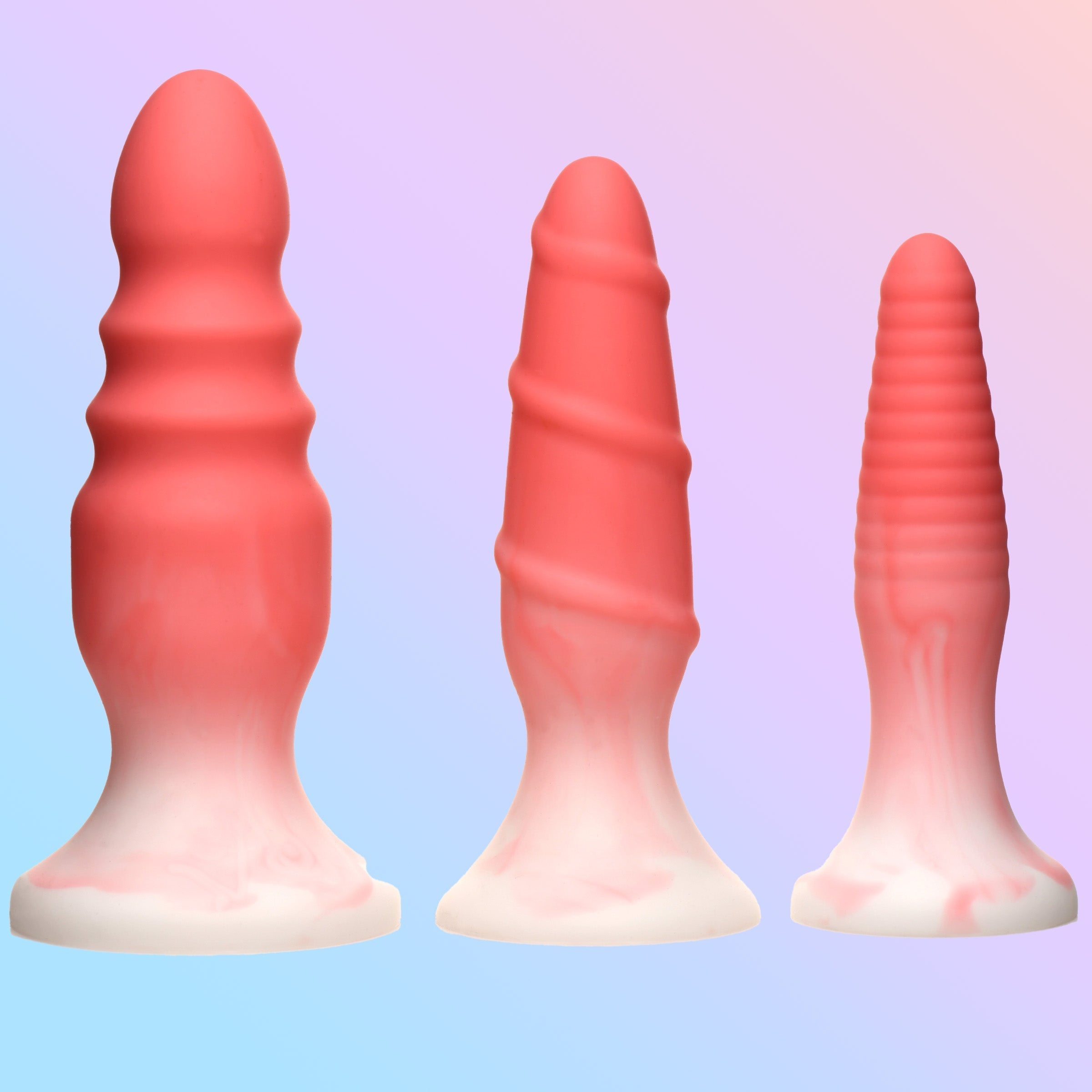 Assortment of pink silicone butt plugs on a blue backdrop