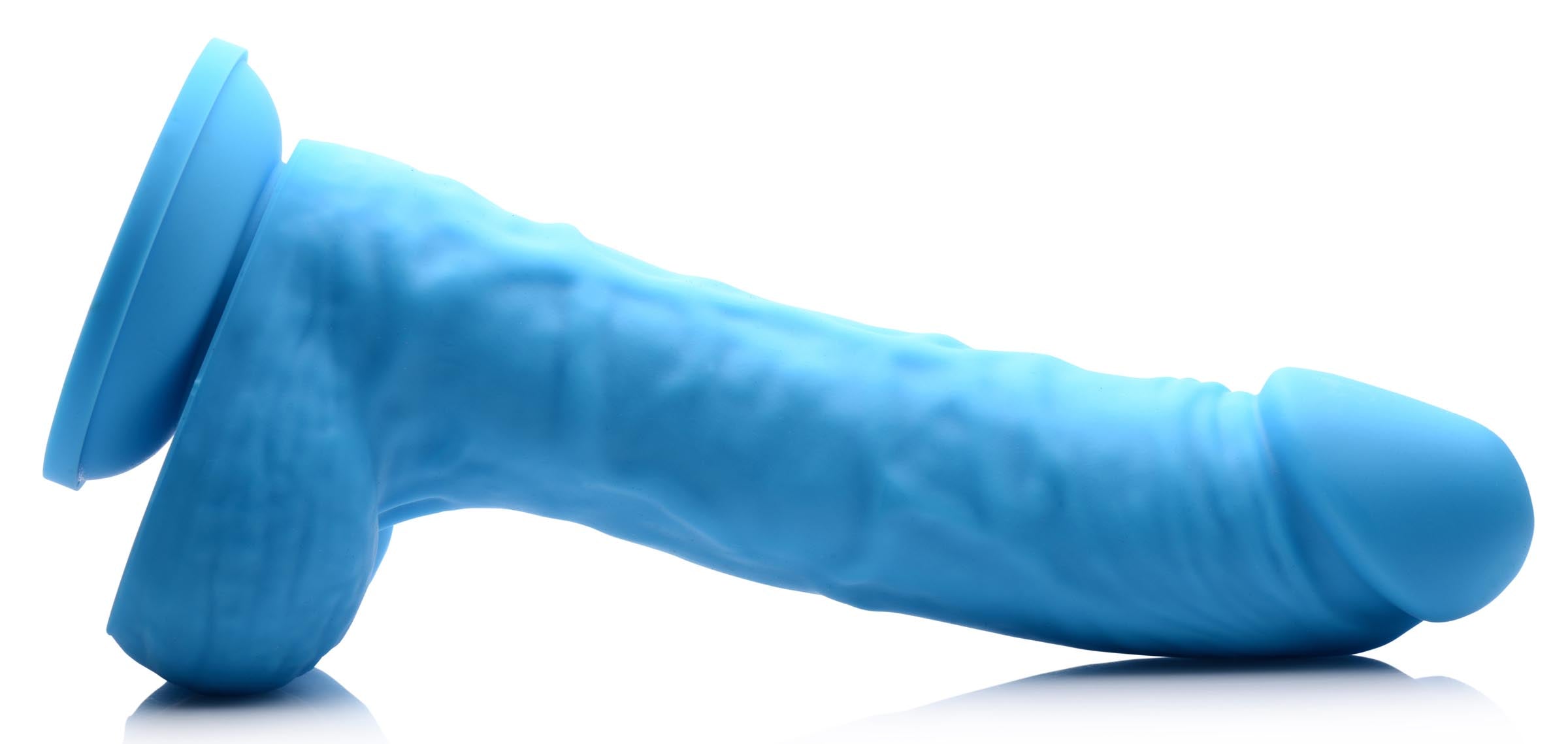 A 7-inch silicone dildo with balls on a white background