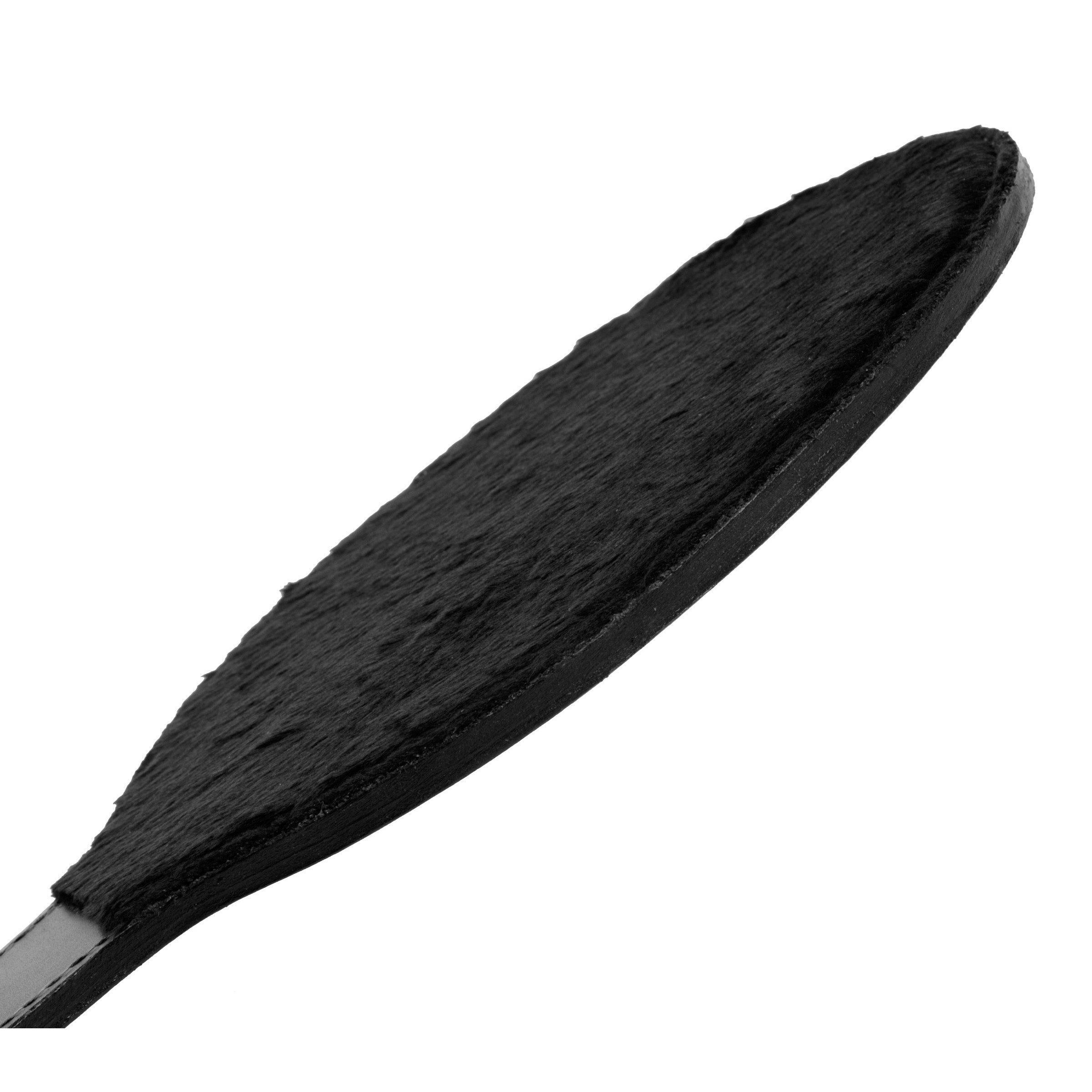 Close-up of a black leather paddle with a round fur-lined surface