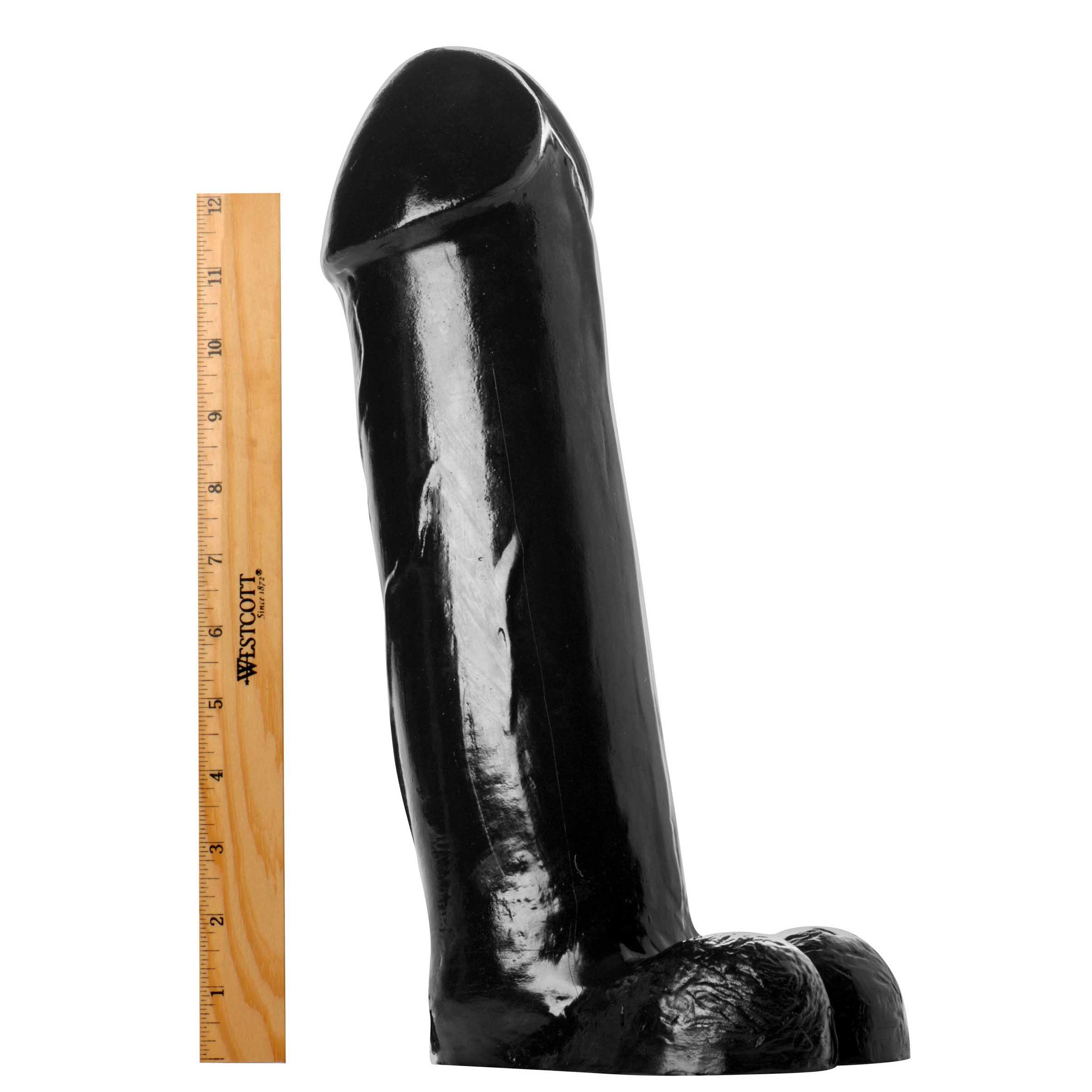 The Titan XXL 14.5 inch dildo beside a measuring ruler for scale