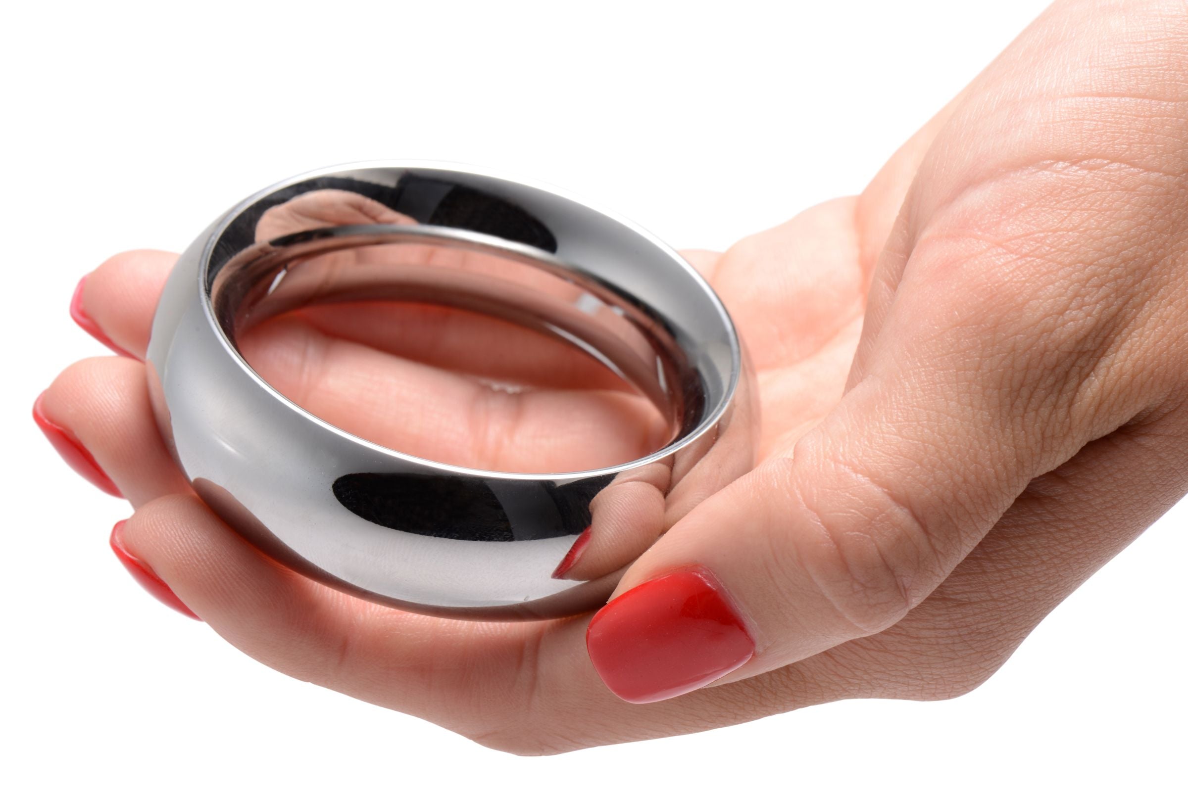 Close-up of a stainless steel cock ring being held by a person