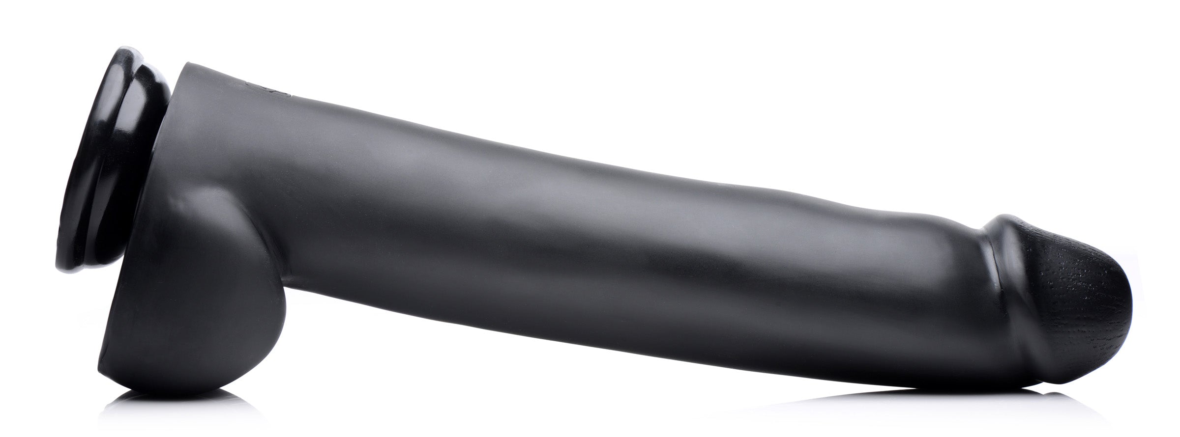 Black suction cup dildo displayed on a white surface