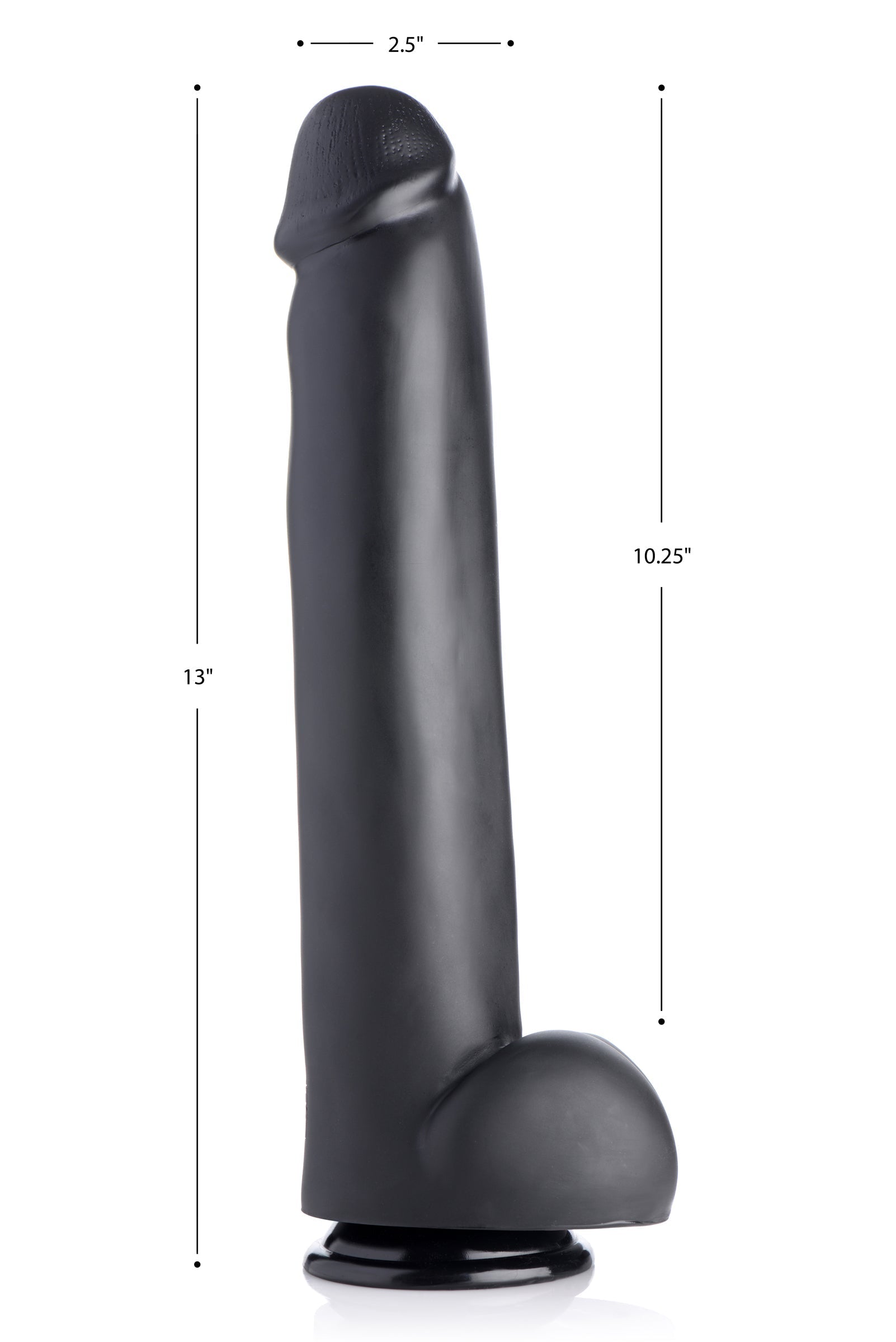 Black dildo with suction cup base alongside a ruler for size reference